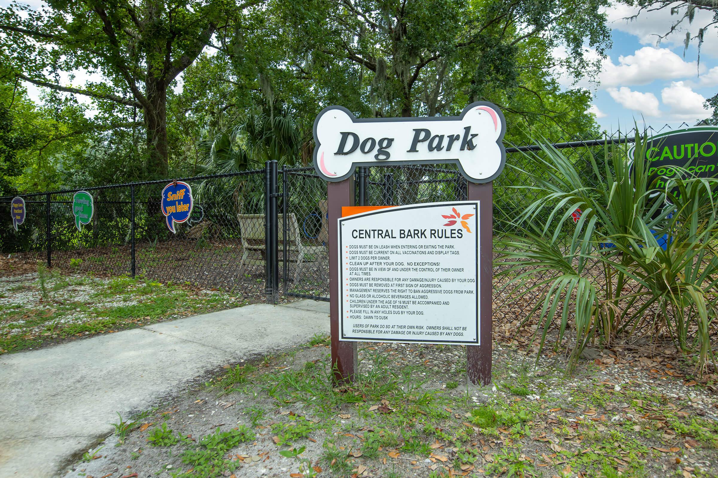 a sign in front of a tree