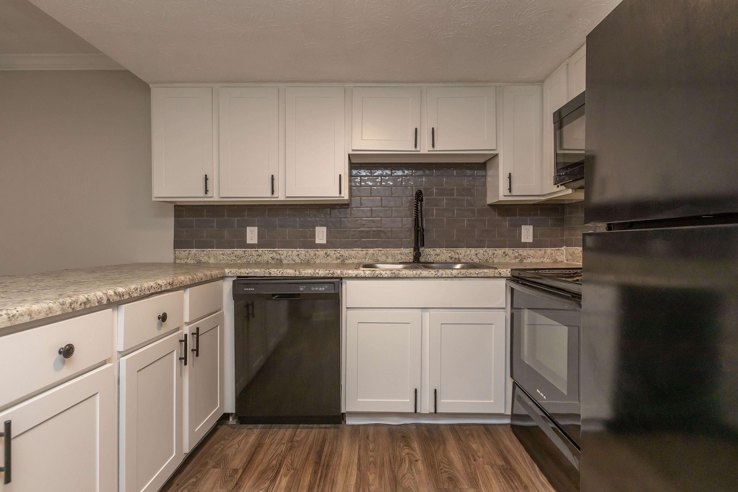 a kitchen with stainless steel appliances and wooden cabinets