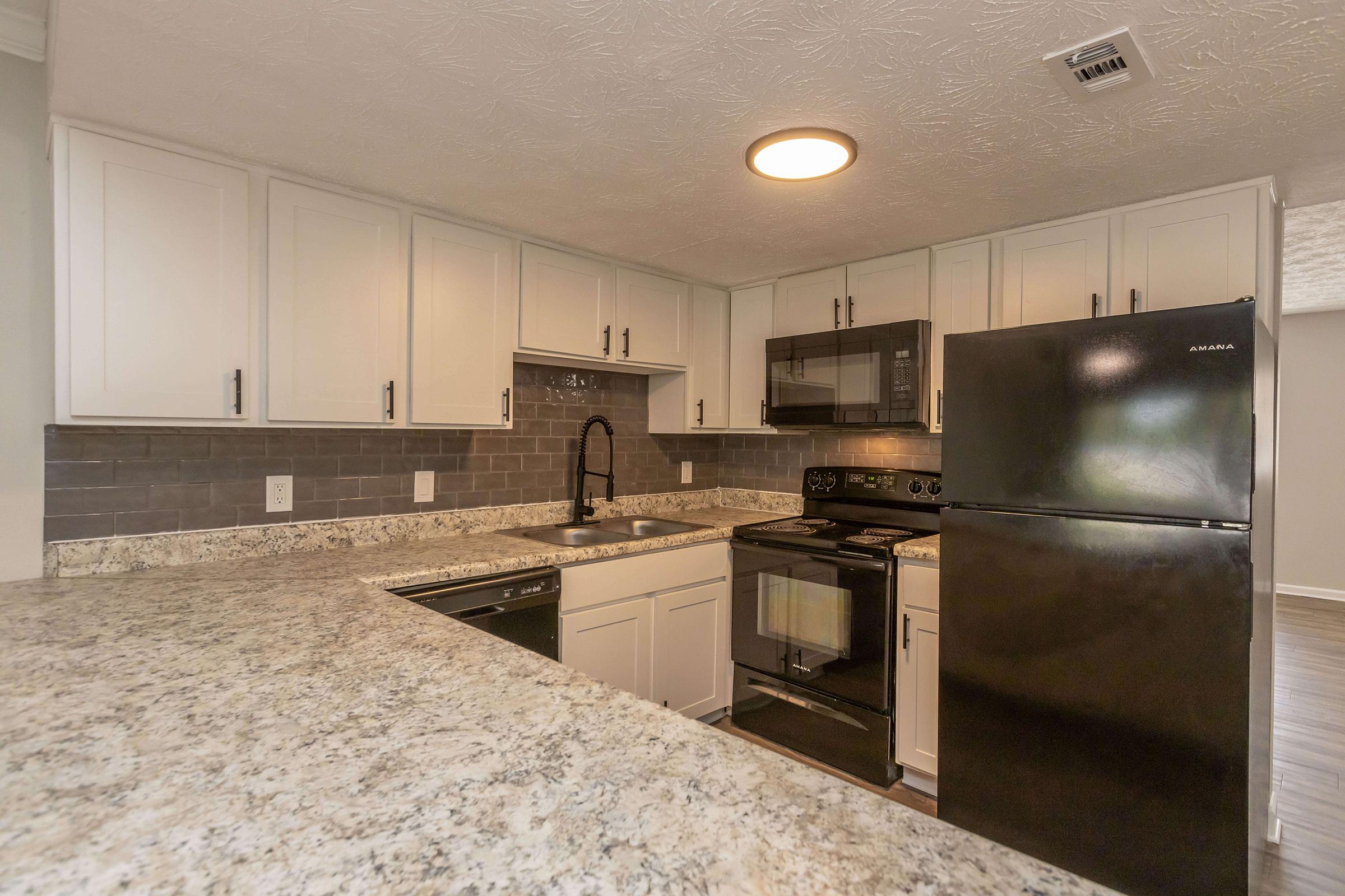 a large kitchen with stainless steel appliances