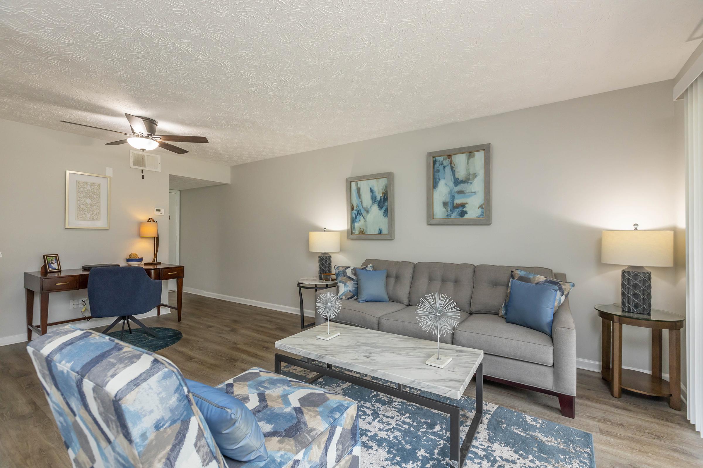 a living room filled with furniture and a bed