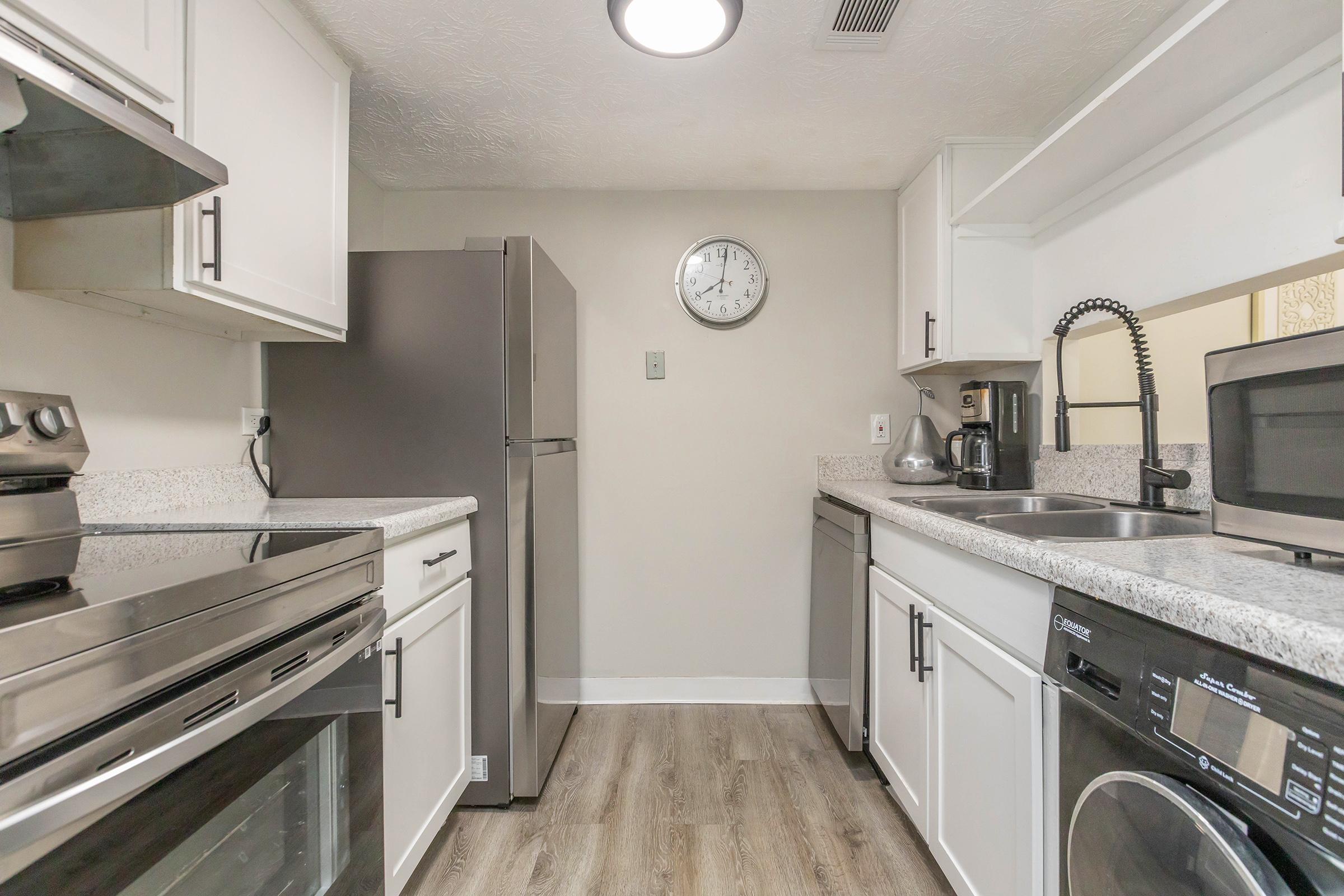 a stove top oven sitting inside of a kitchen