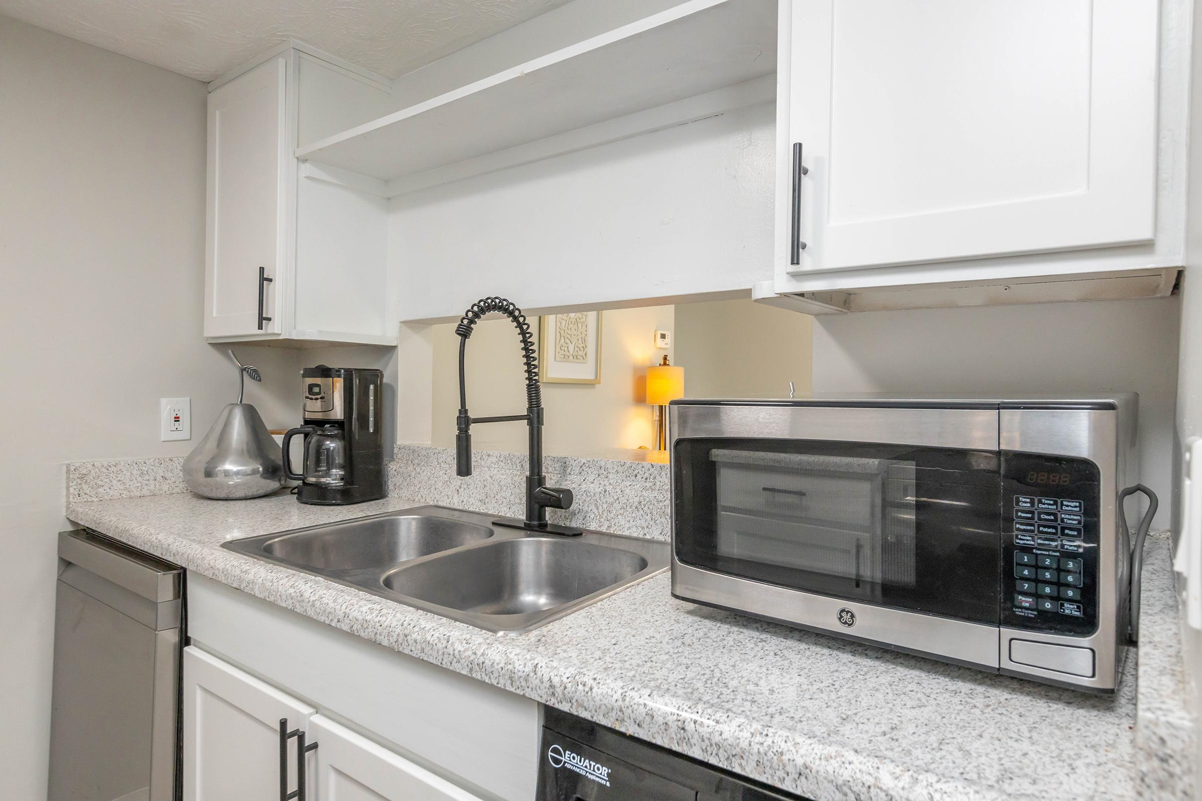 a kitchen with a sink and a microwave