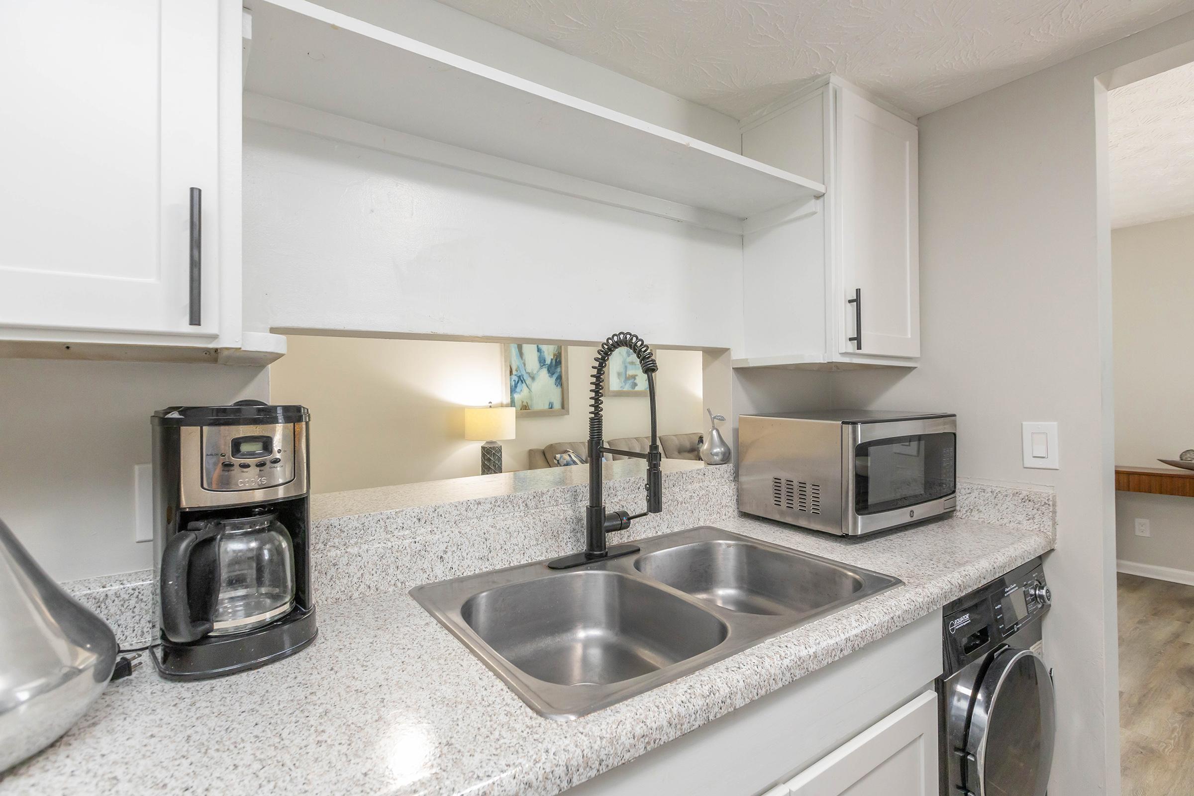 a kitchen with a sink and a microwave