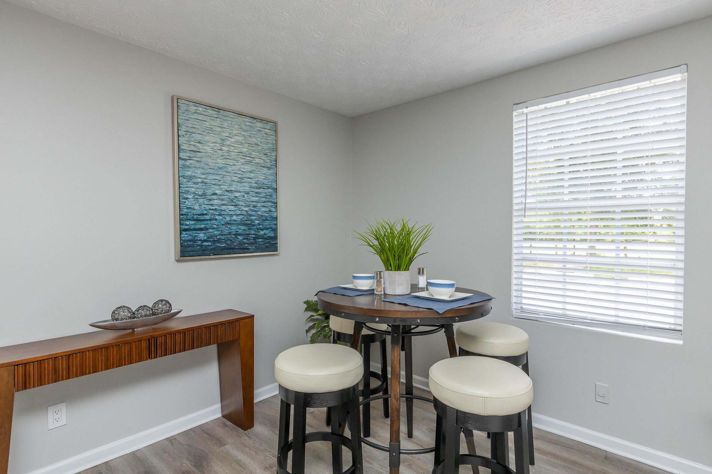 a living room filled with furniture and a large window