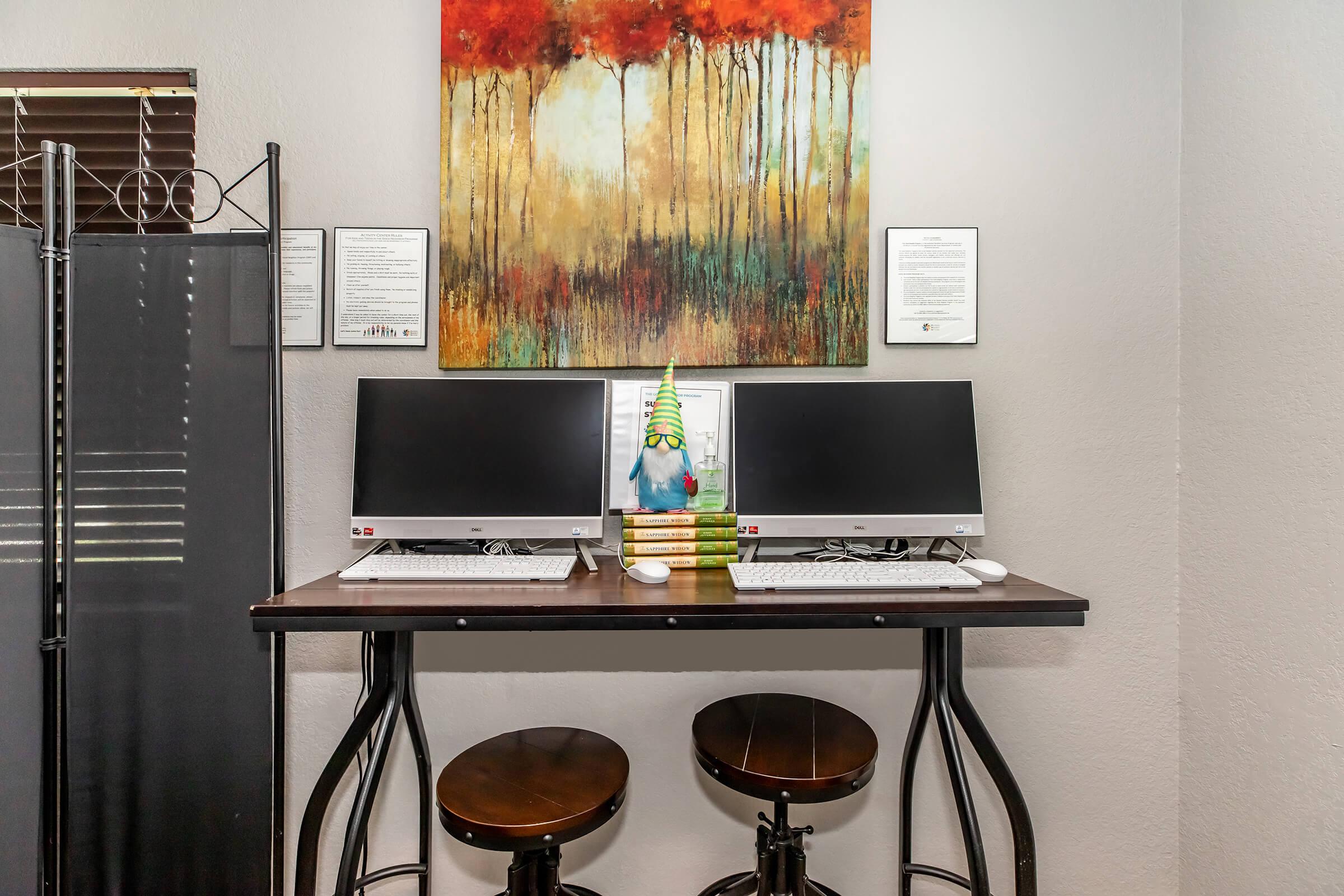 a desk with a laptop computer sitting on top of a table