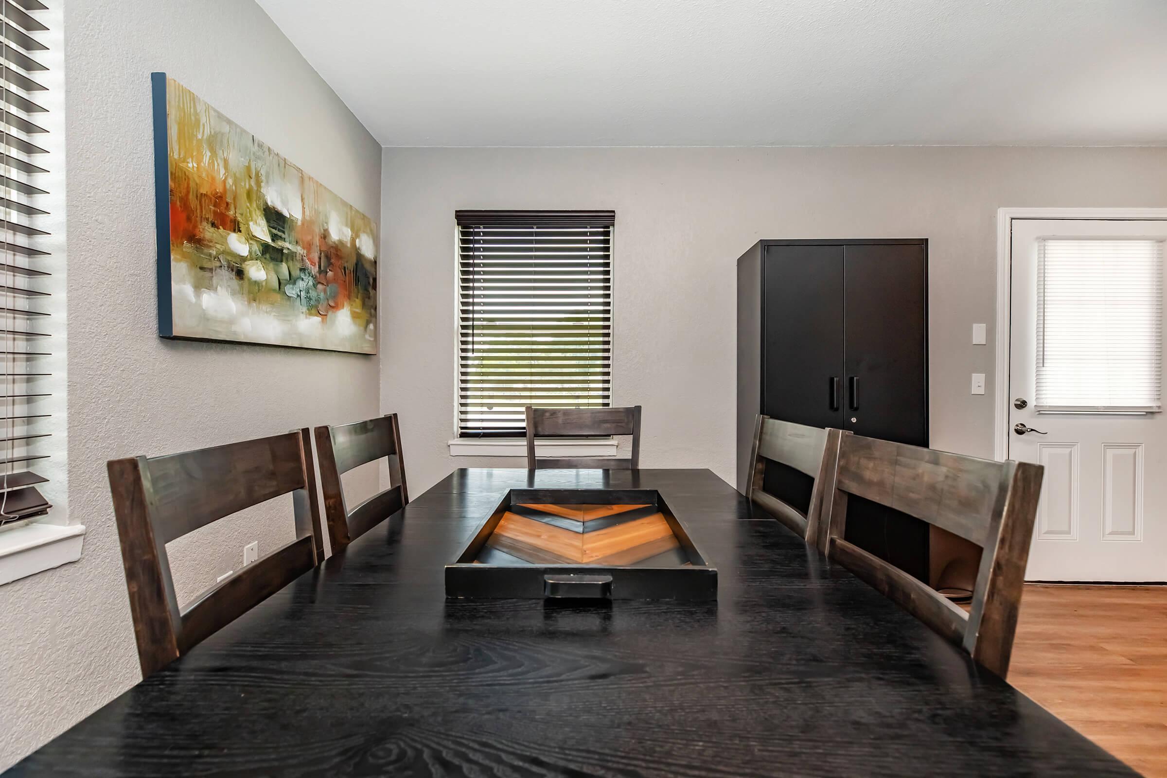 a living room filled with furniture and a wood floor