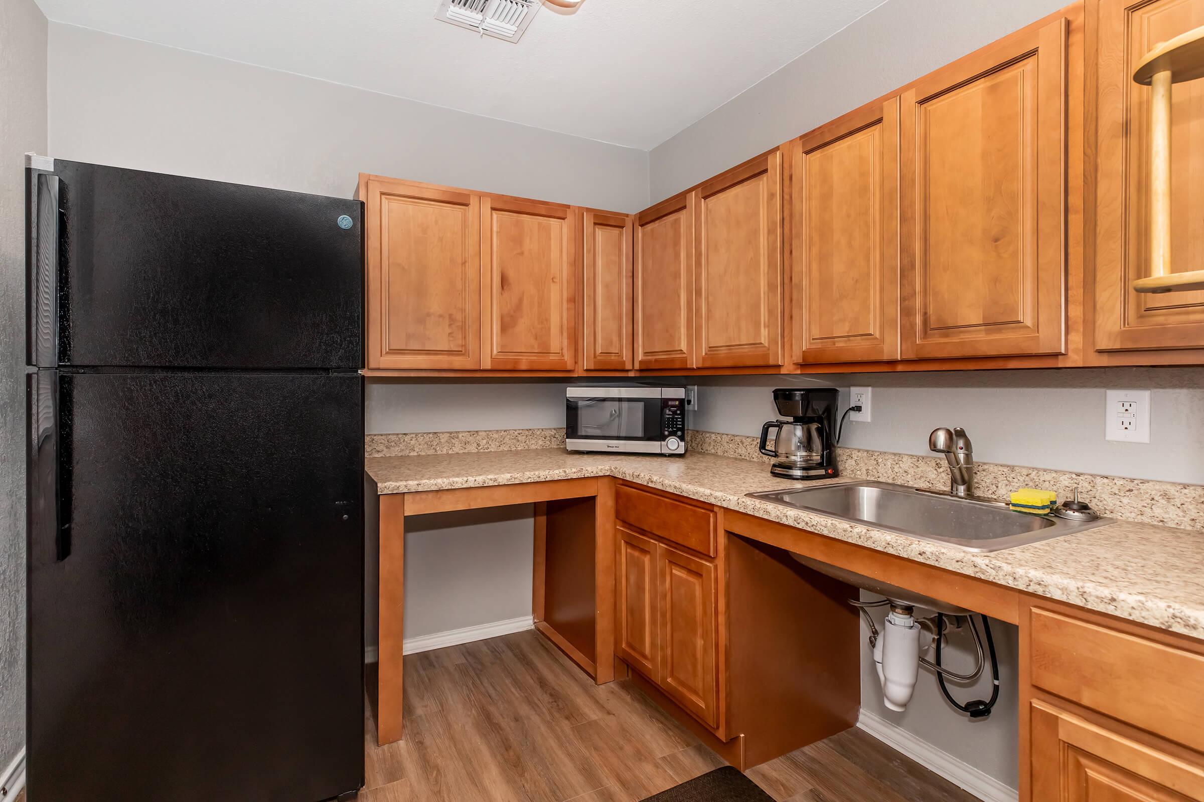 a kitchen with stainless steel appliances and wooden cabinets