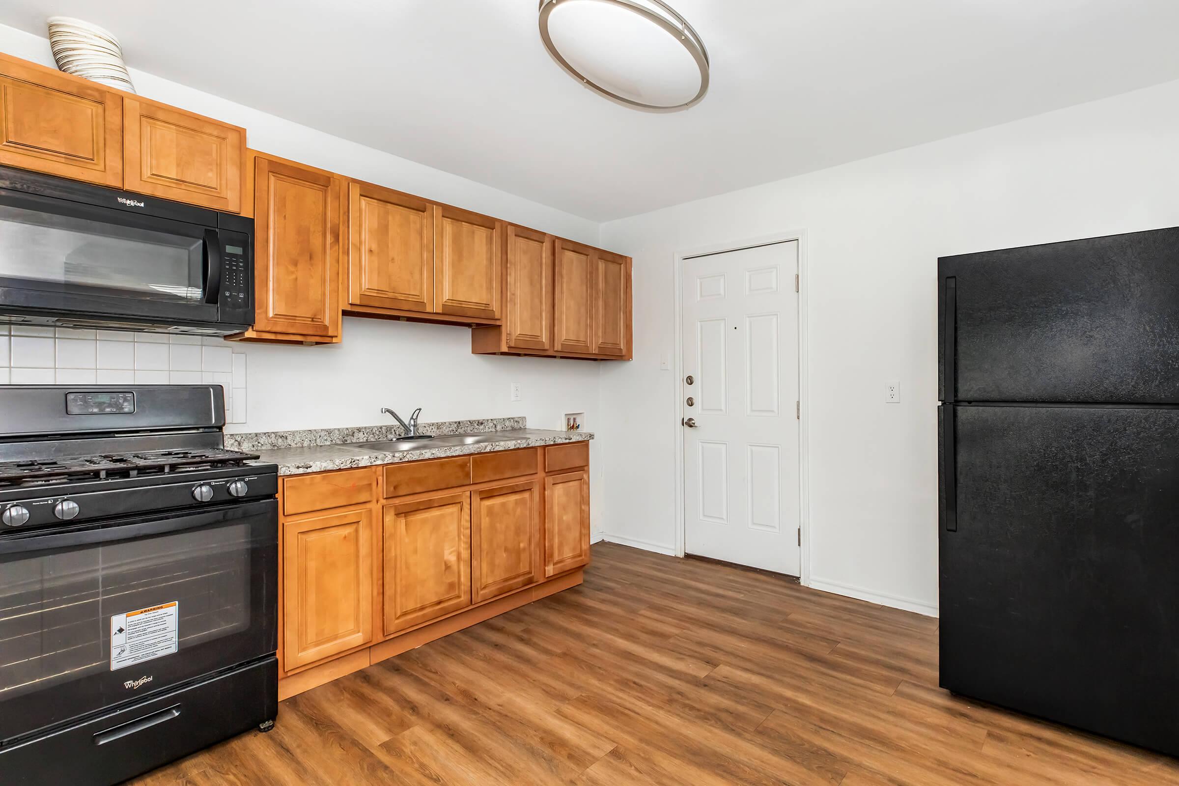 a kitchen with stainless steel appliances and wooden cabinets