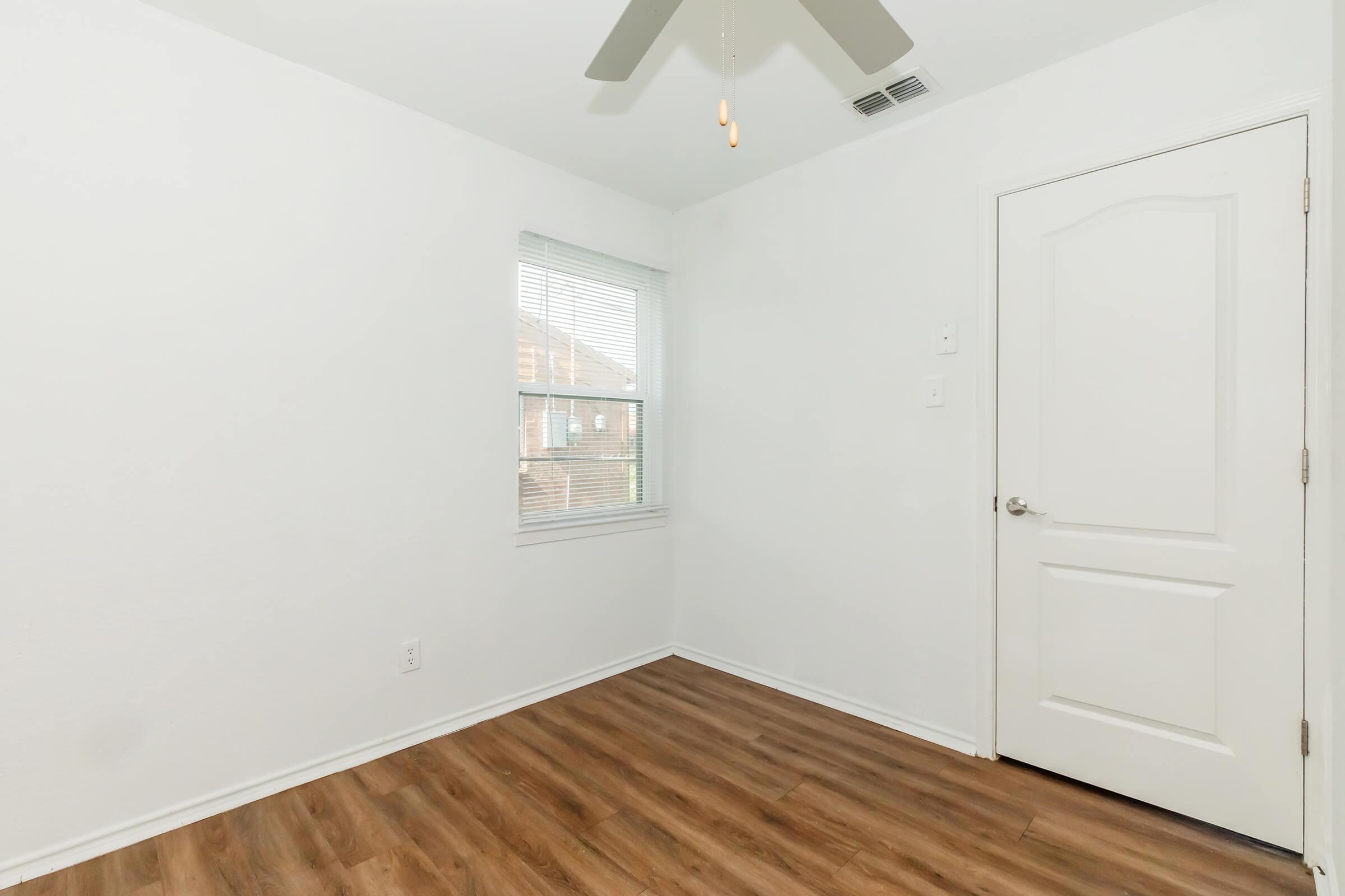 a kitchen with wooden cabinets and a window