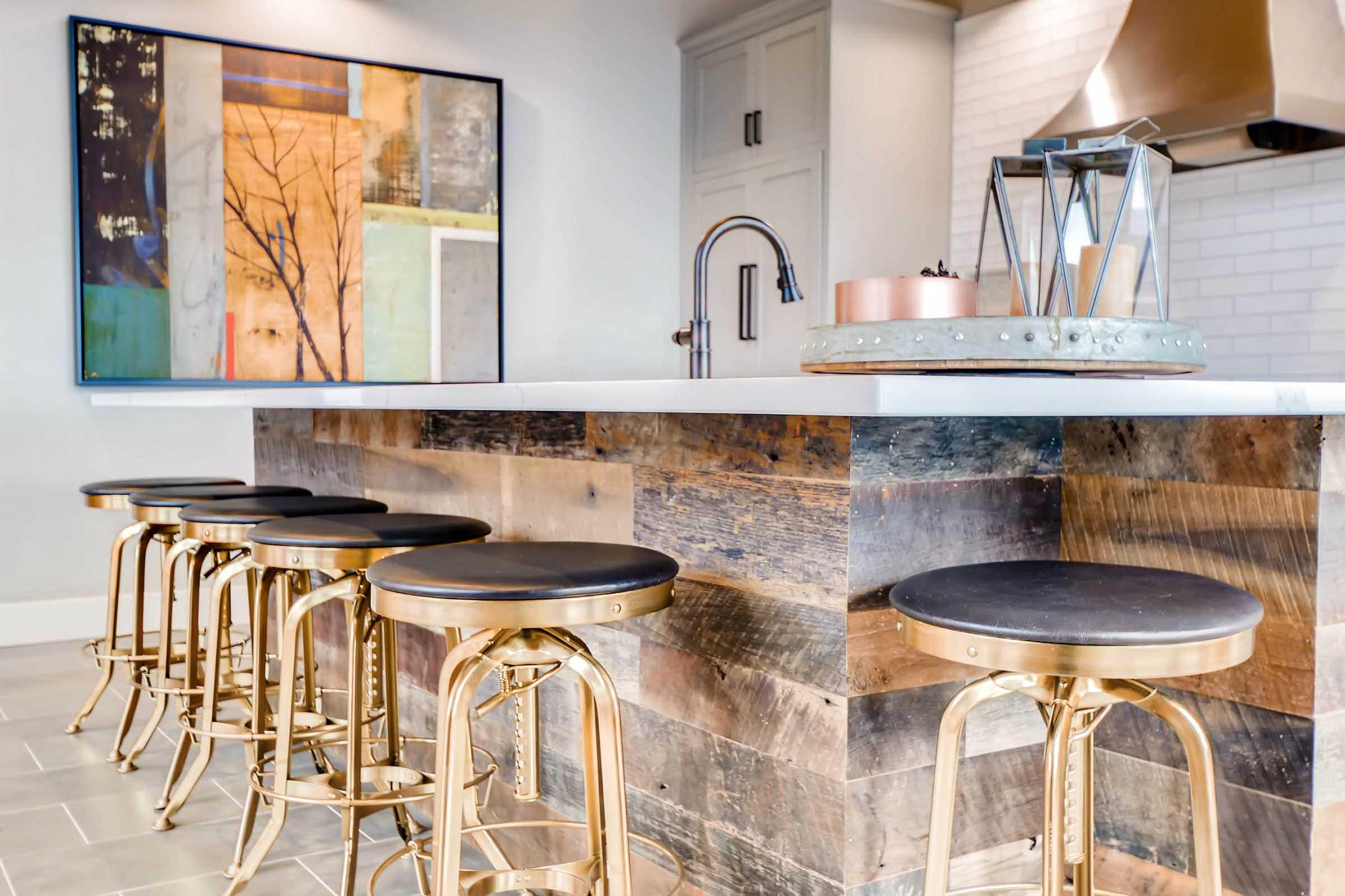 A modern kitchen featuring a large island with a wooden base and a smooth white countertop.
