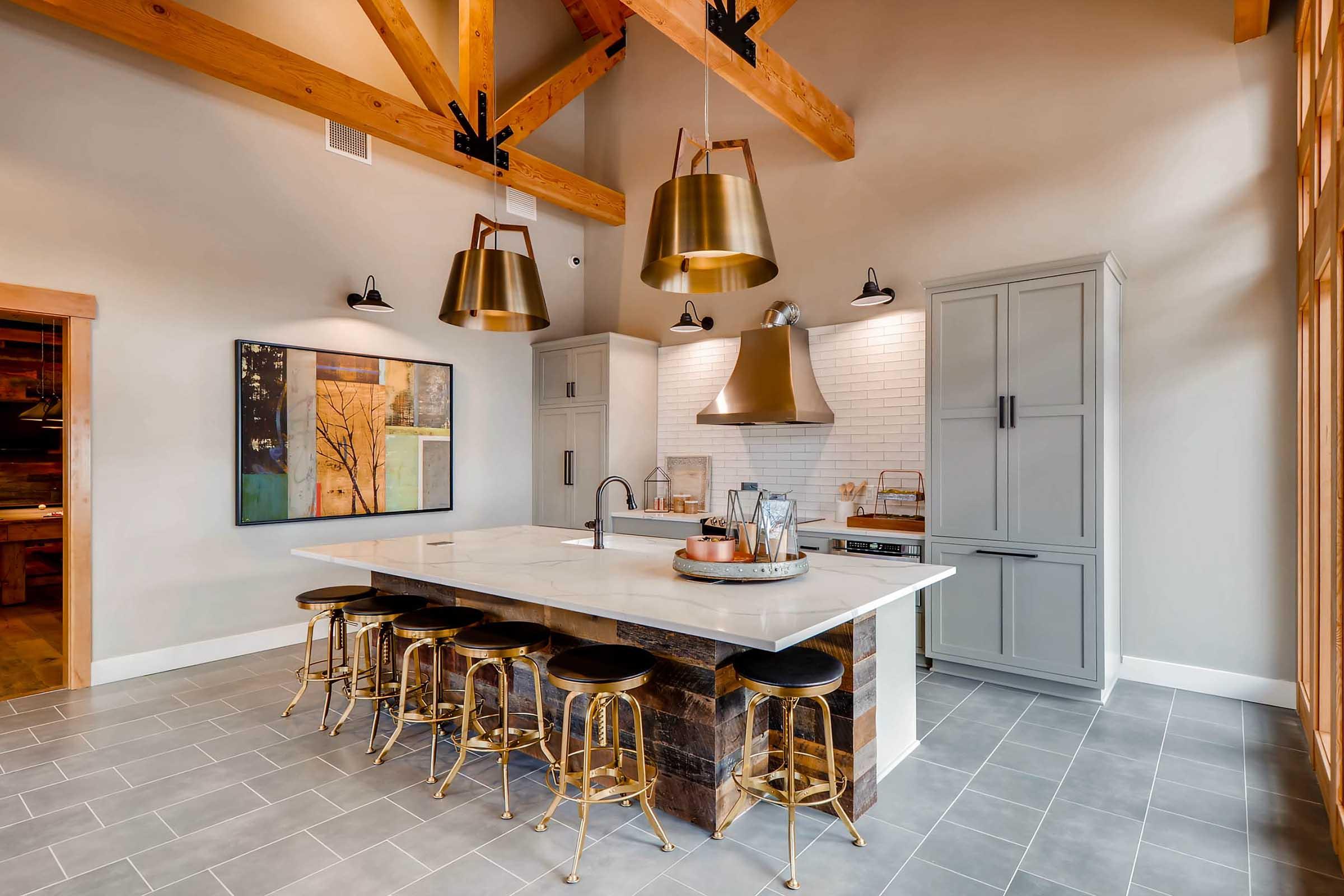 Modern kitchen featuring a large island with a white countertop and dark wood accents.