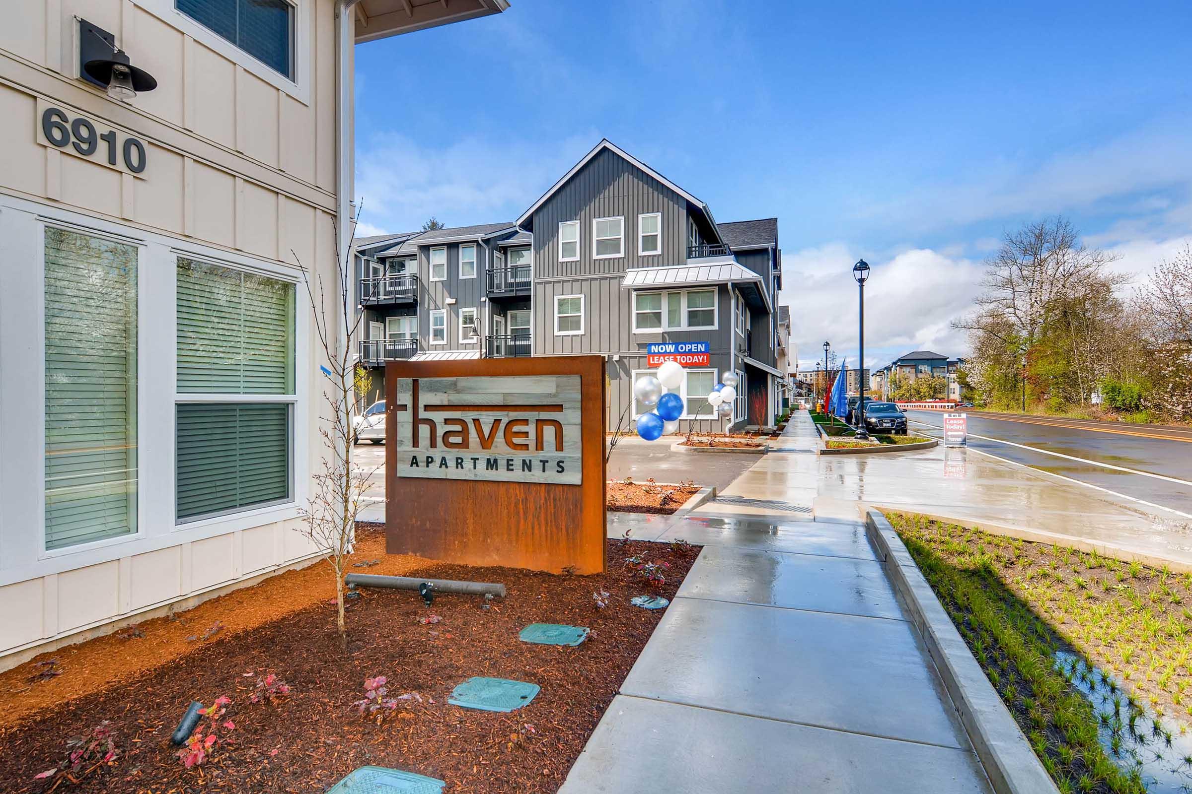 Signage for Haven Apartments prominently displayed in front of a modern apartment complex.