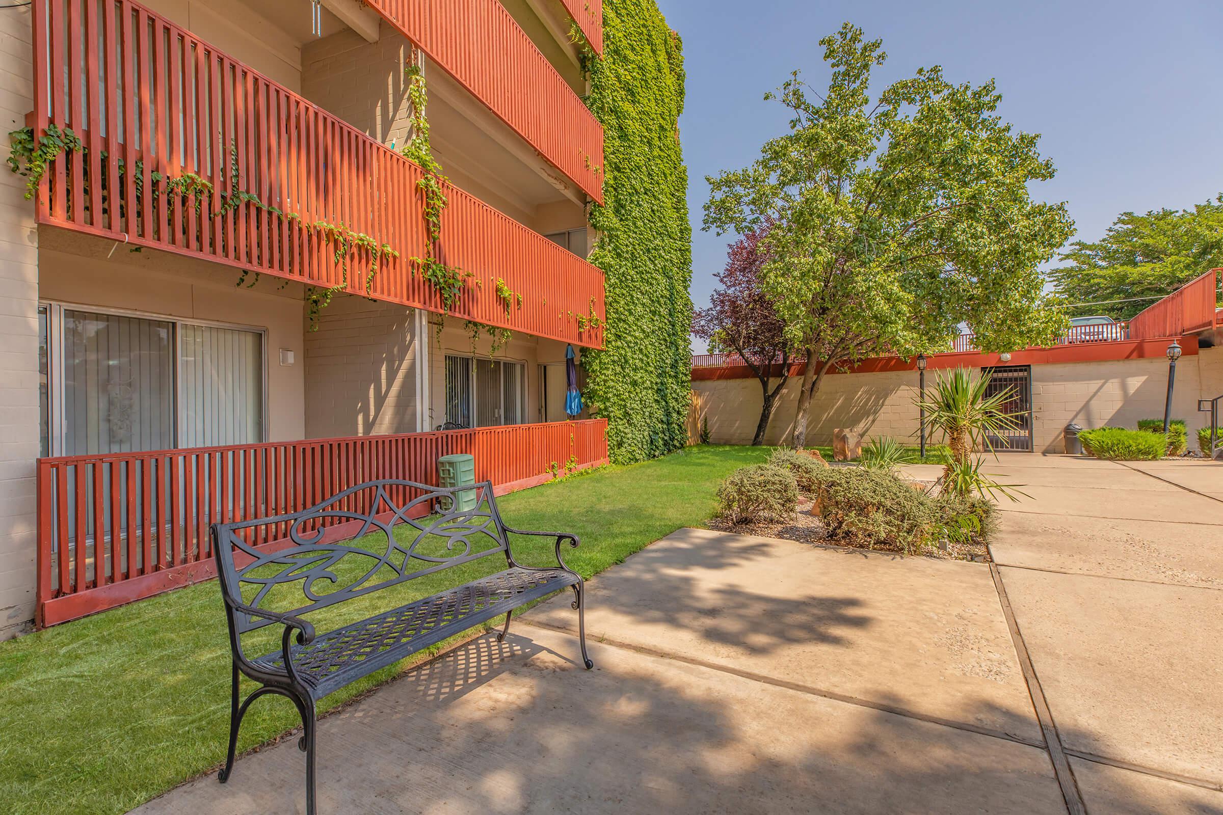 a metal bench next to a community building