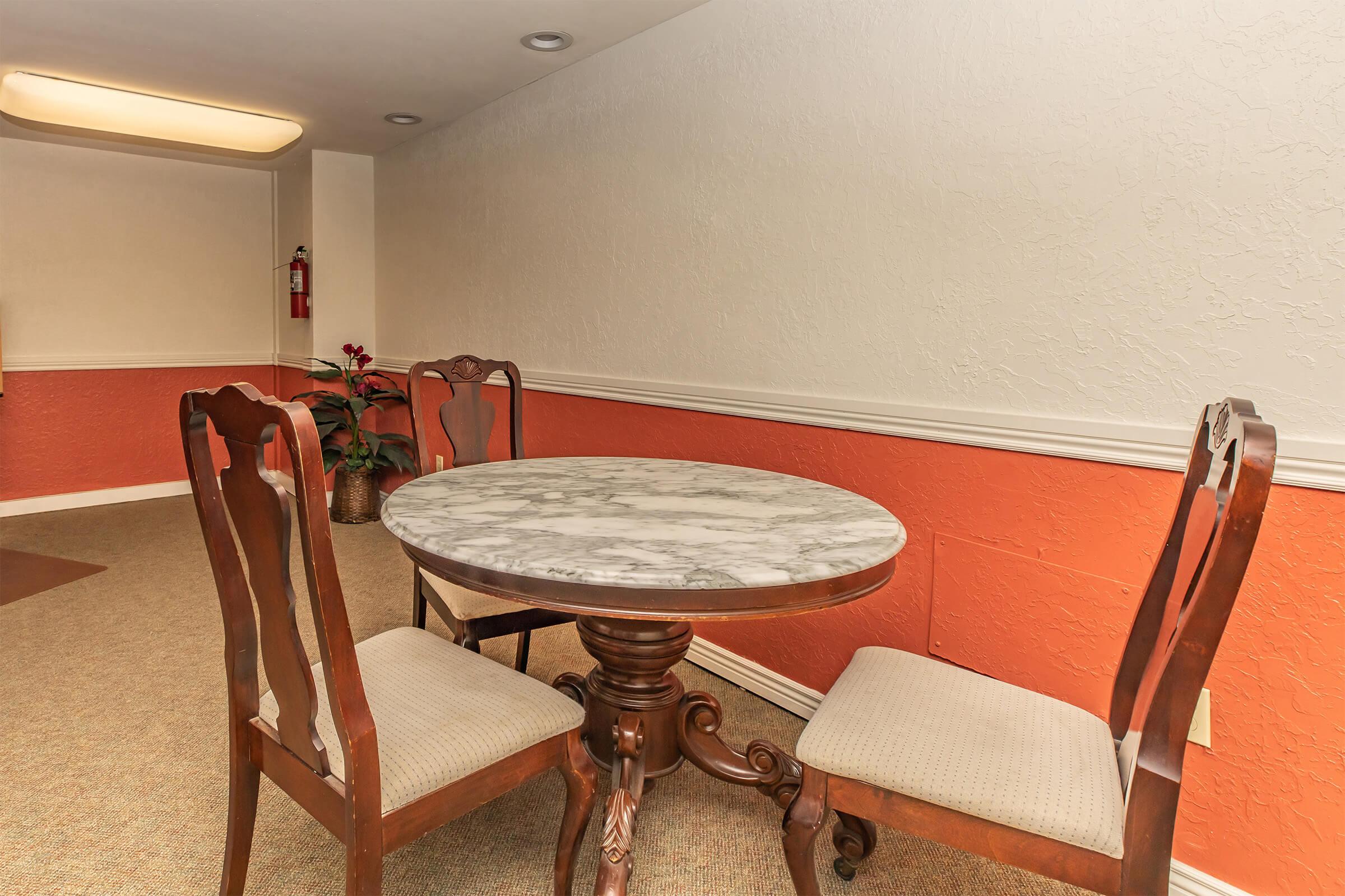 a table and chairs in the community room