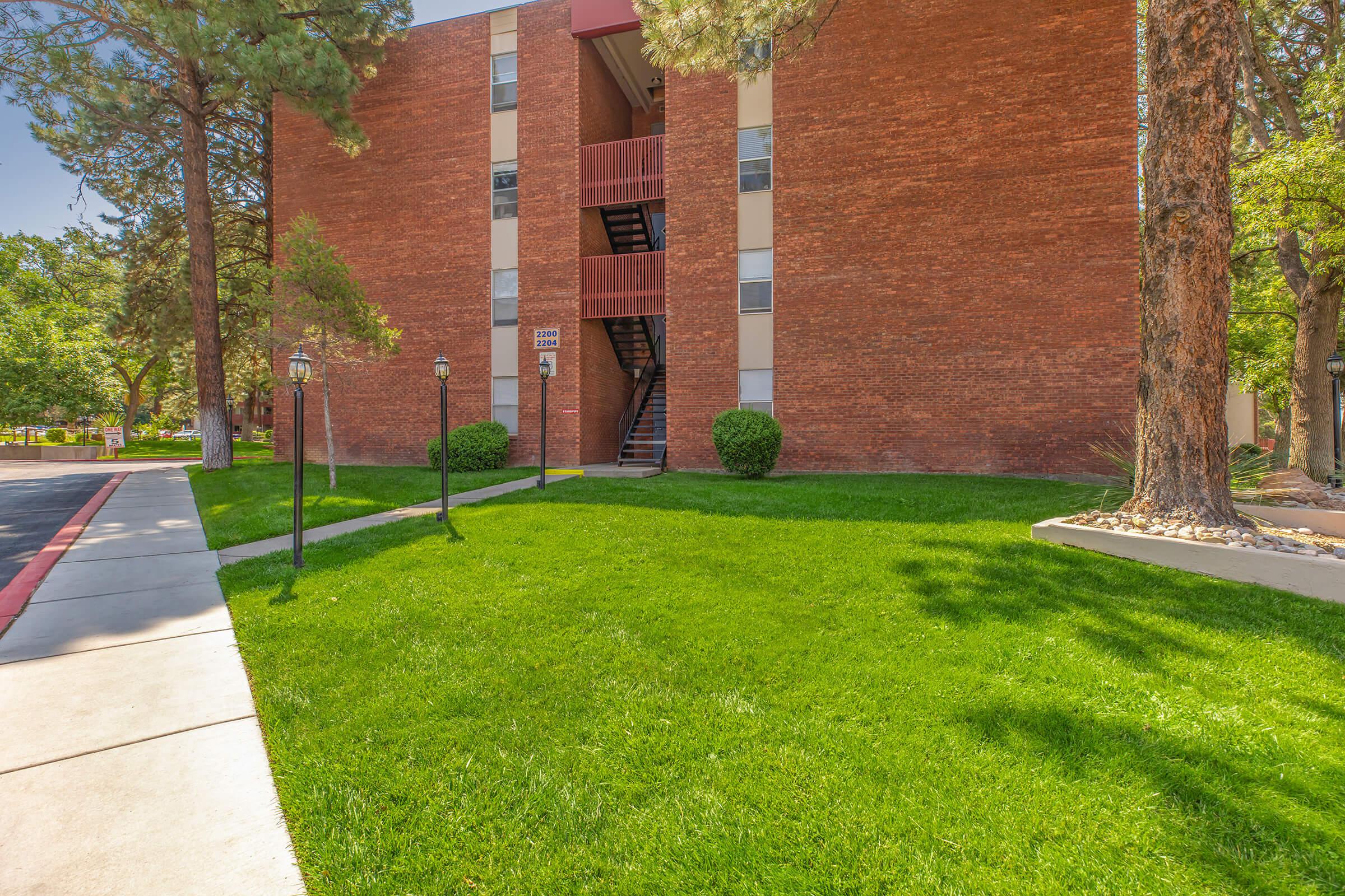 Three Fountains community building with green grass