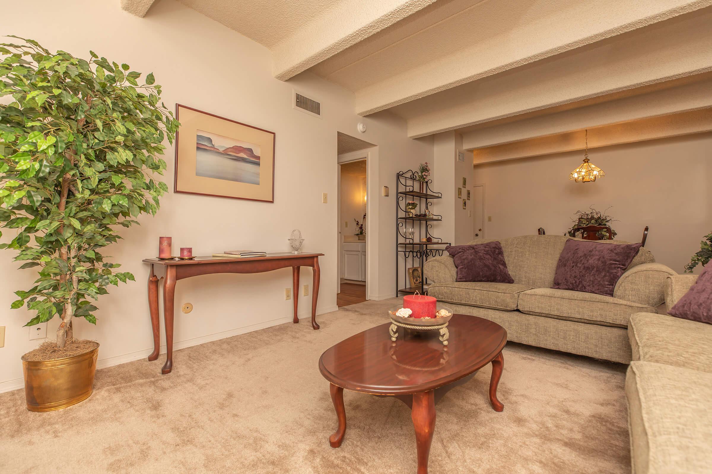 carpeted living room with a coffee table