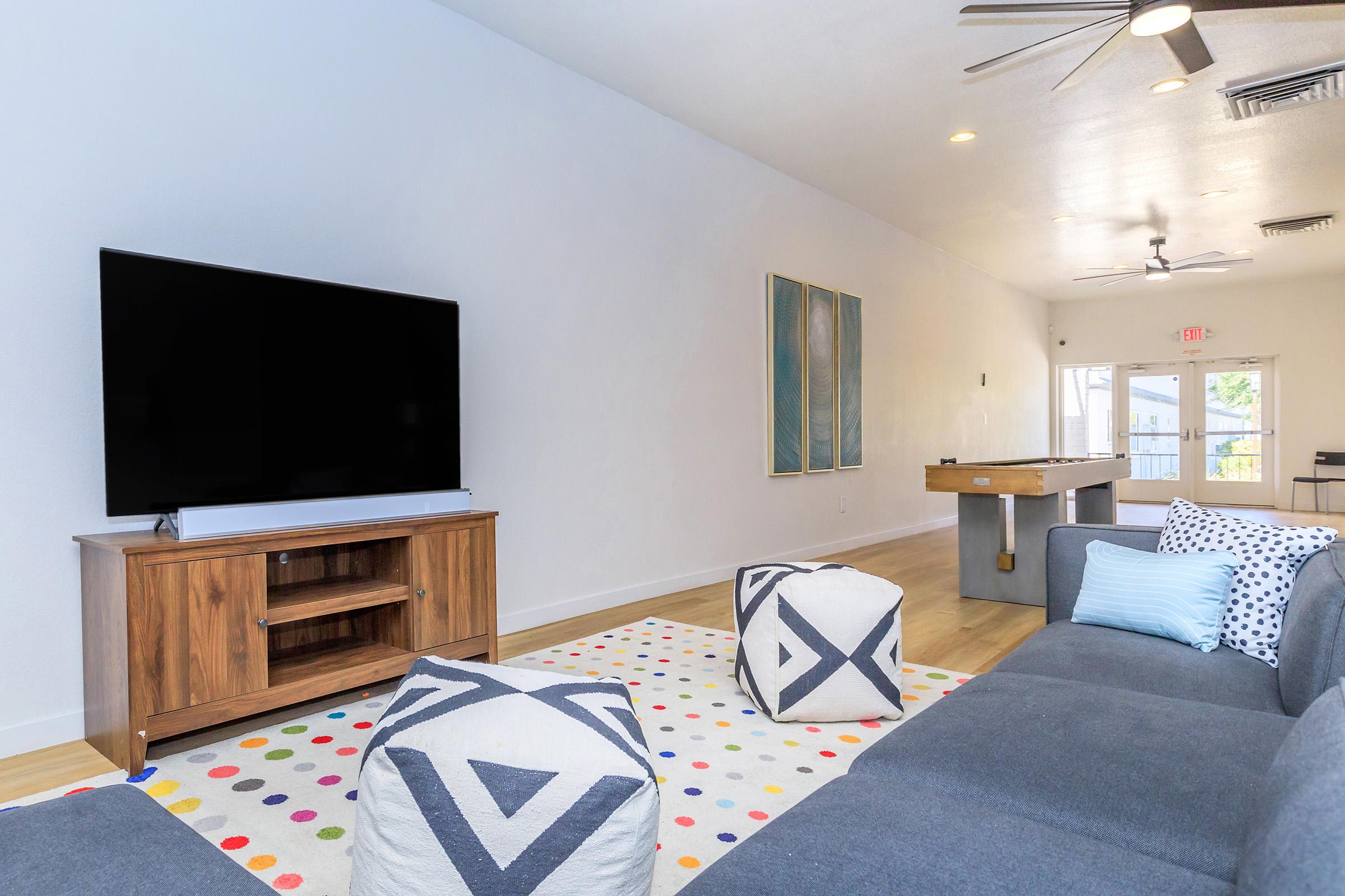 a living room filled with furniture and a rug