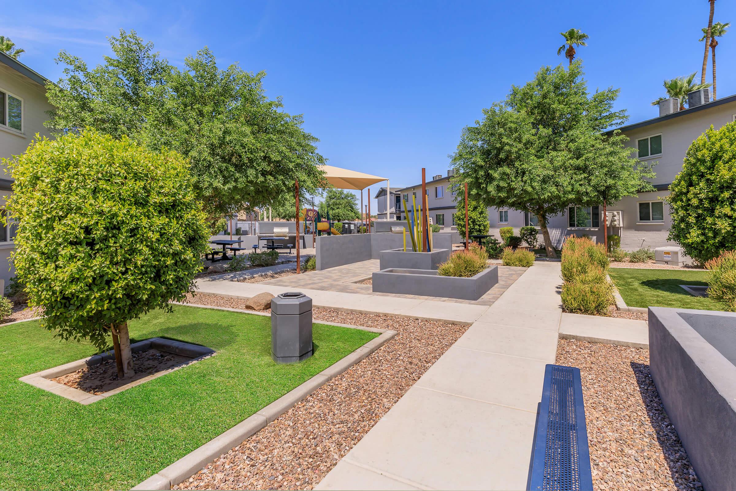 a path with trees on the side of a building