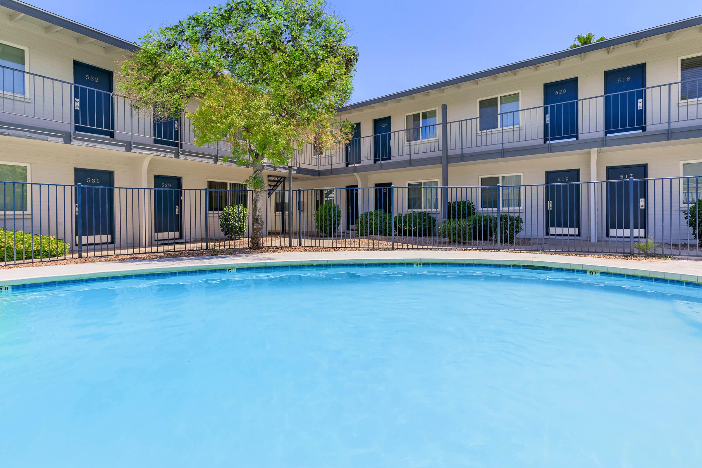 a blue pool of water in front of a building