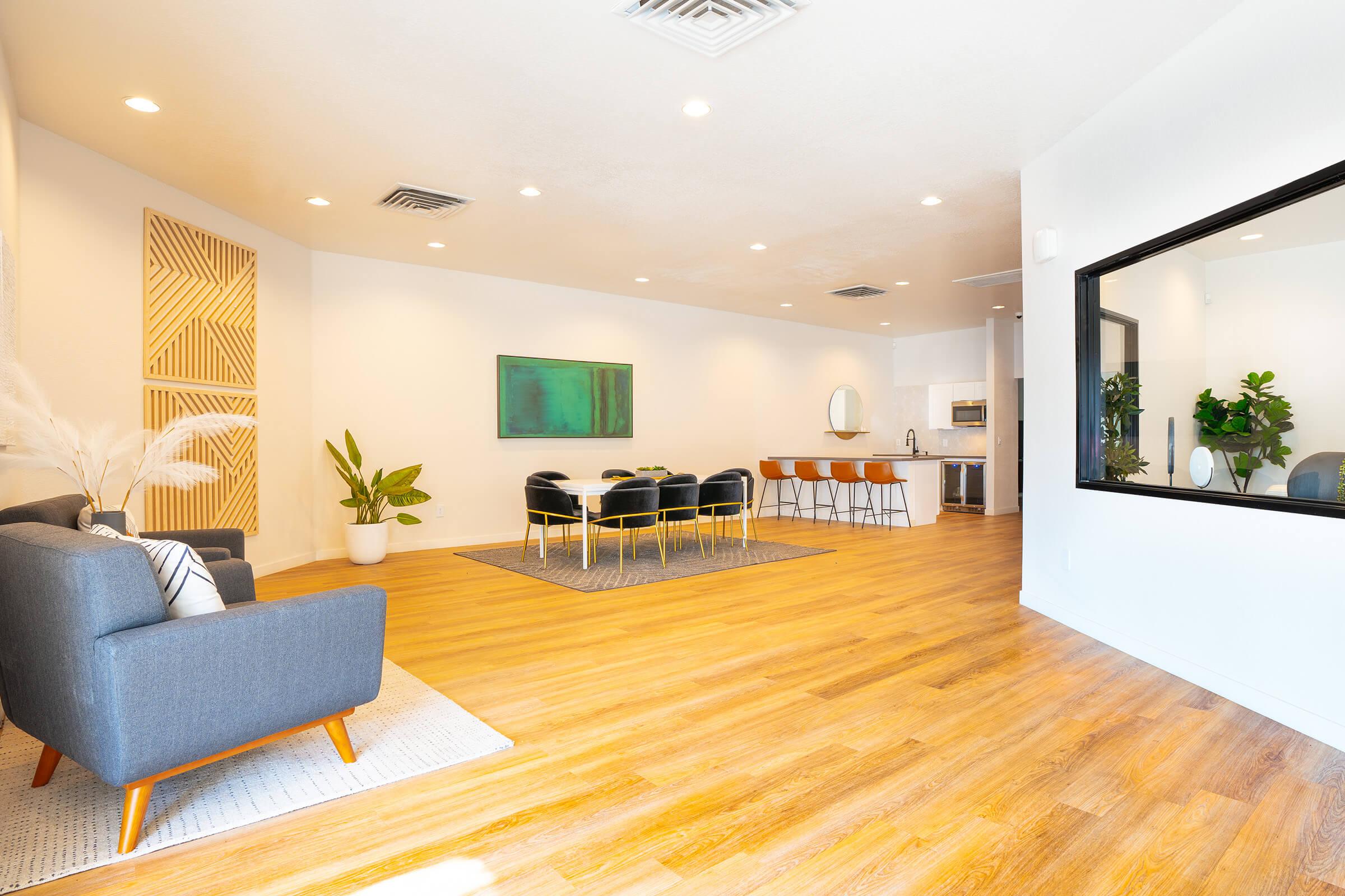 a living room filled with furniture and a large window