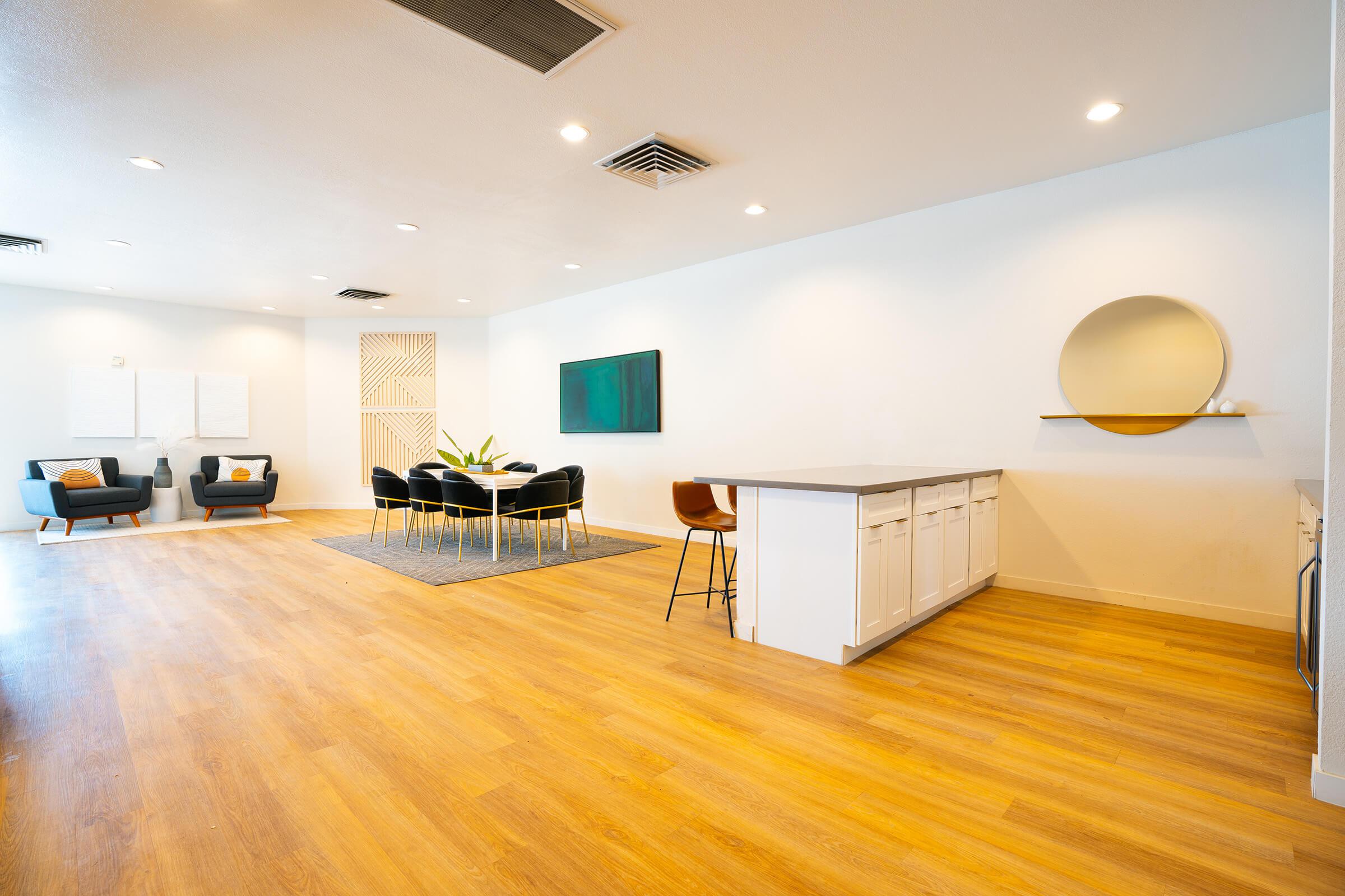 a living room filled with furniture on top of a hard wood floor