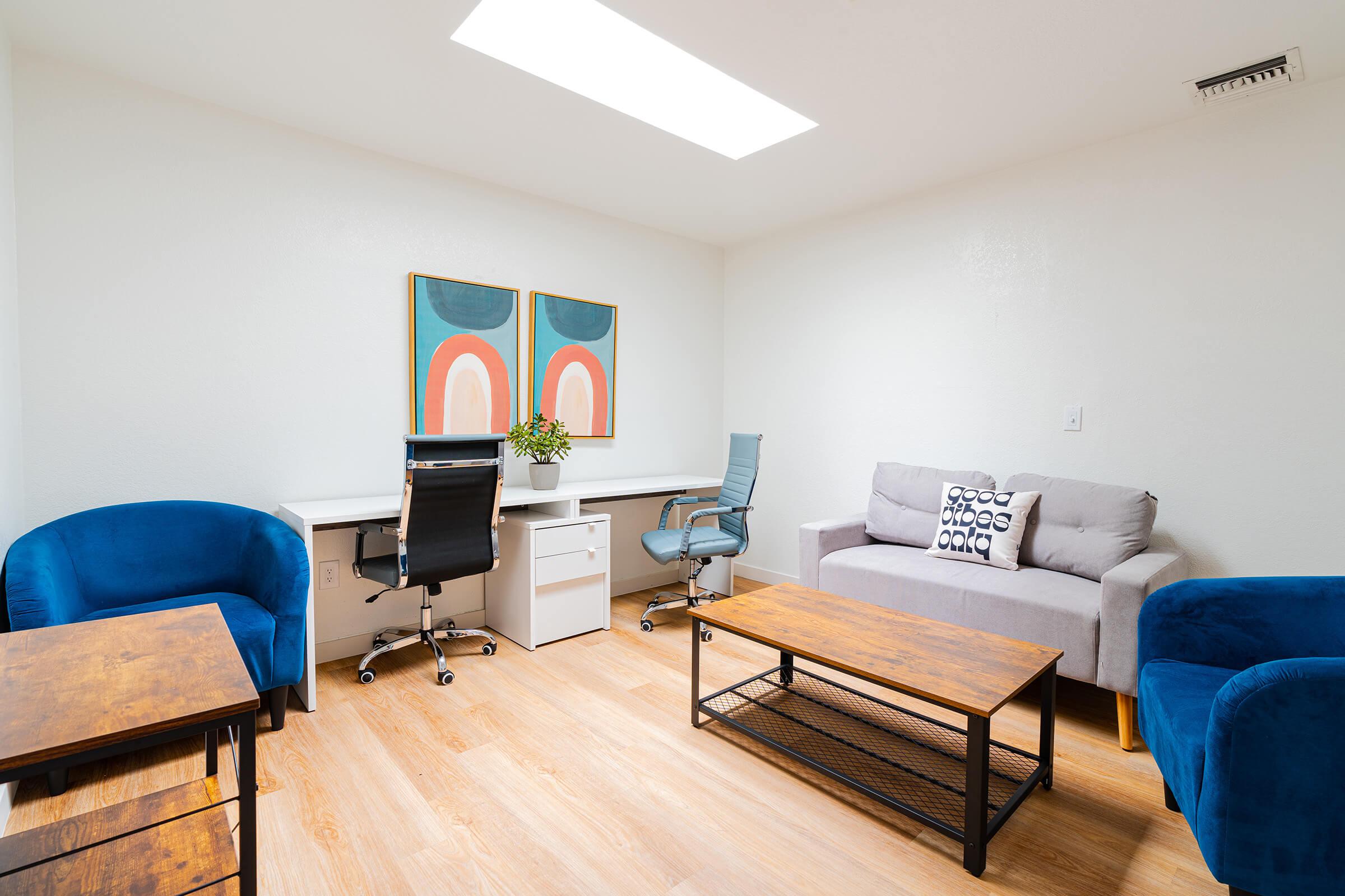 a living room filled with furniture and a blue chair