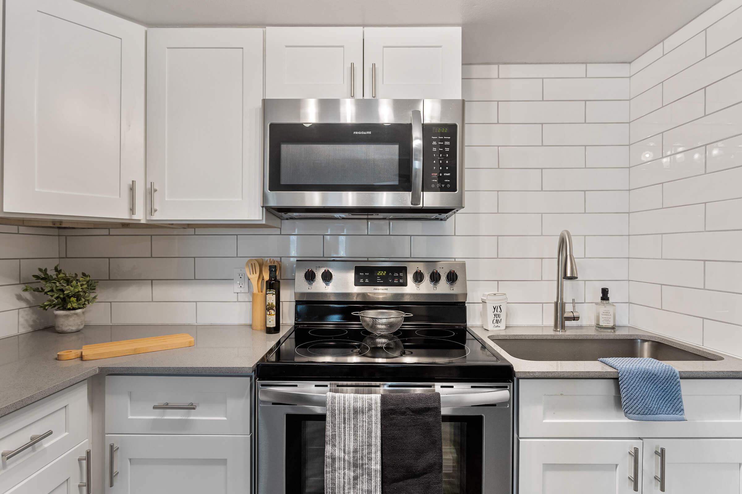 a stove top oven sitting inside of a kitchen