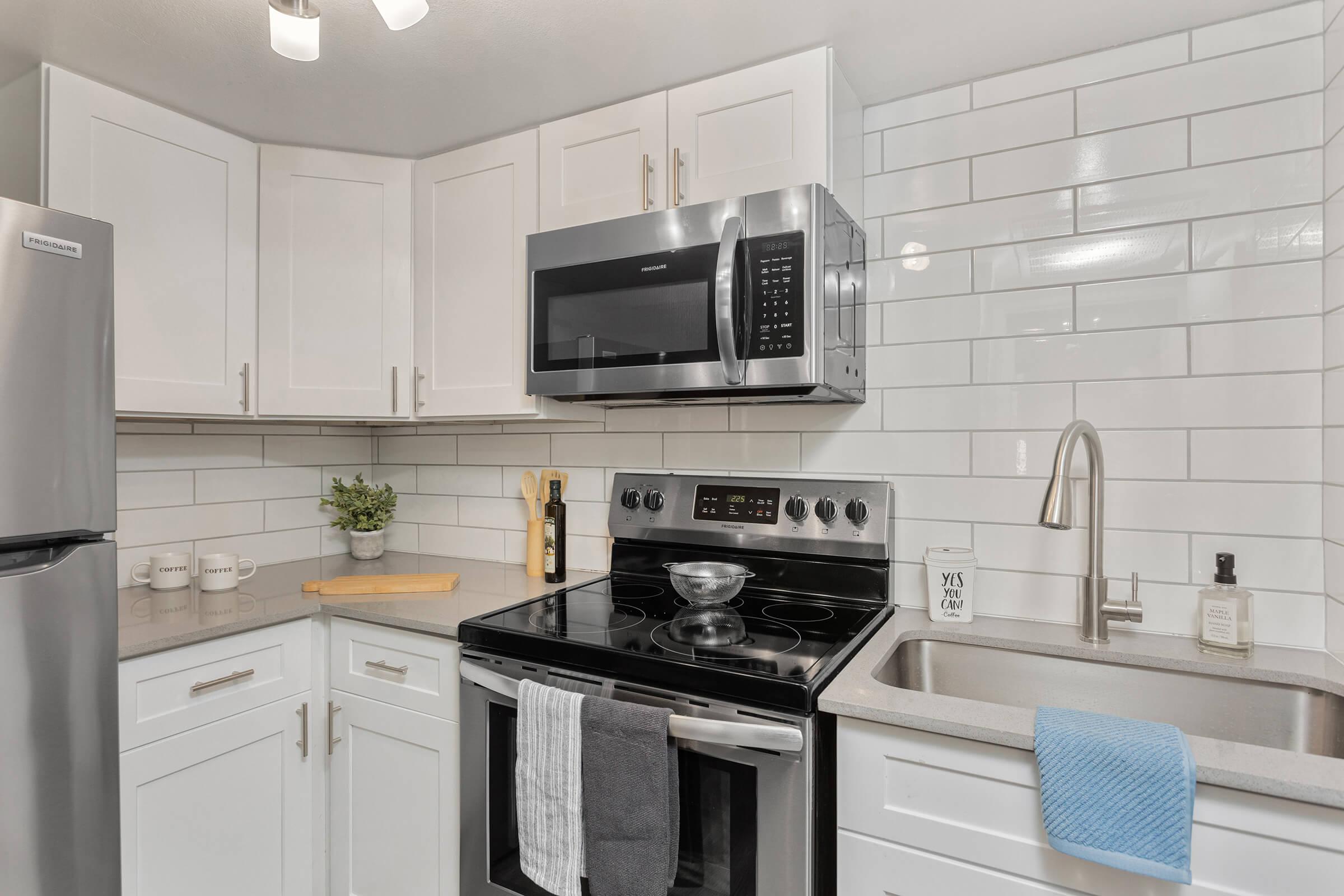 a stove top oven sitting inside of a kitchen