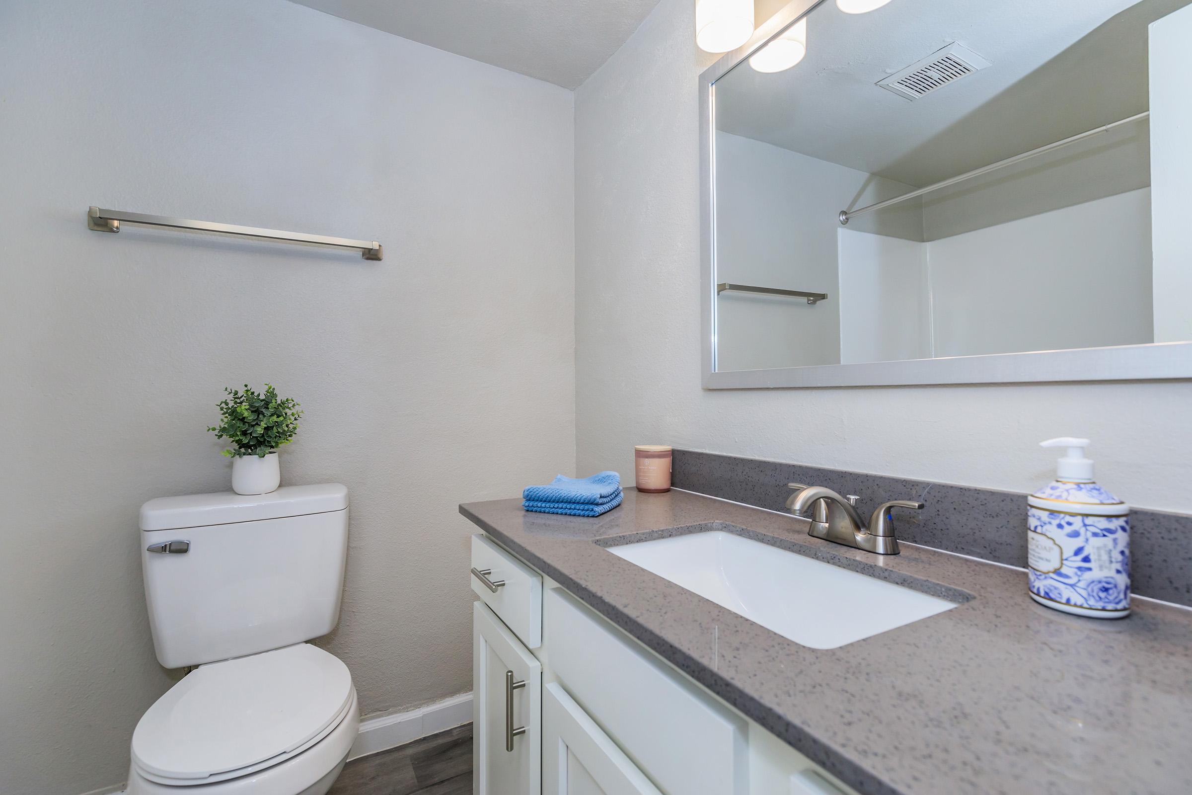 a kitchen with a sink and a mirror