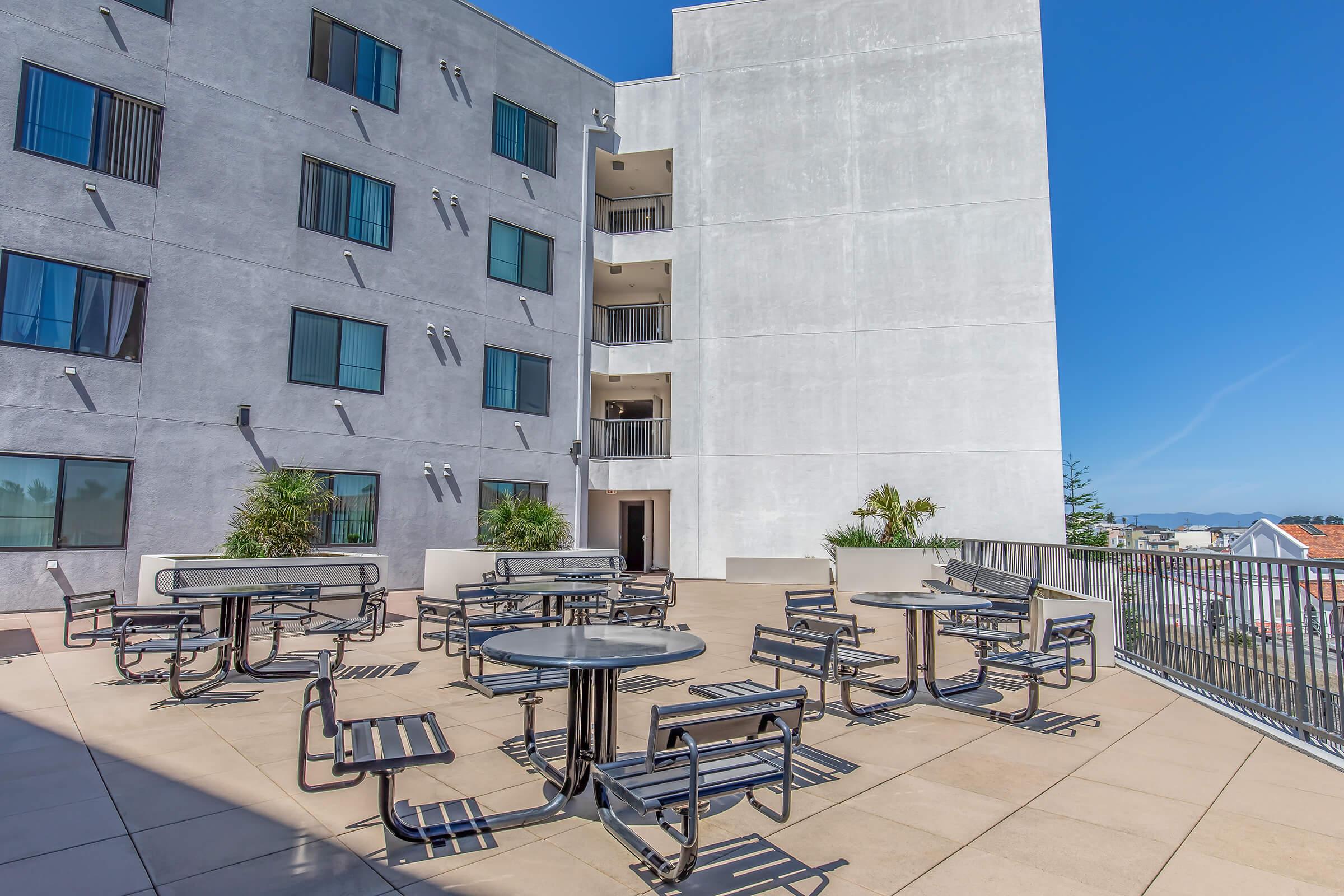 a row of park benches sitting in front of a building