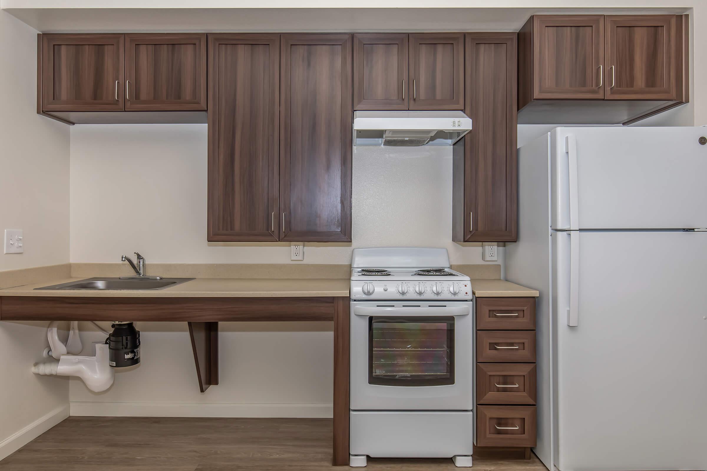 a kitchen with a stove top oven sitting inside of a refrigerator