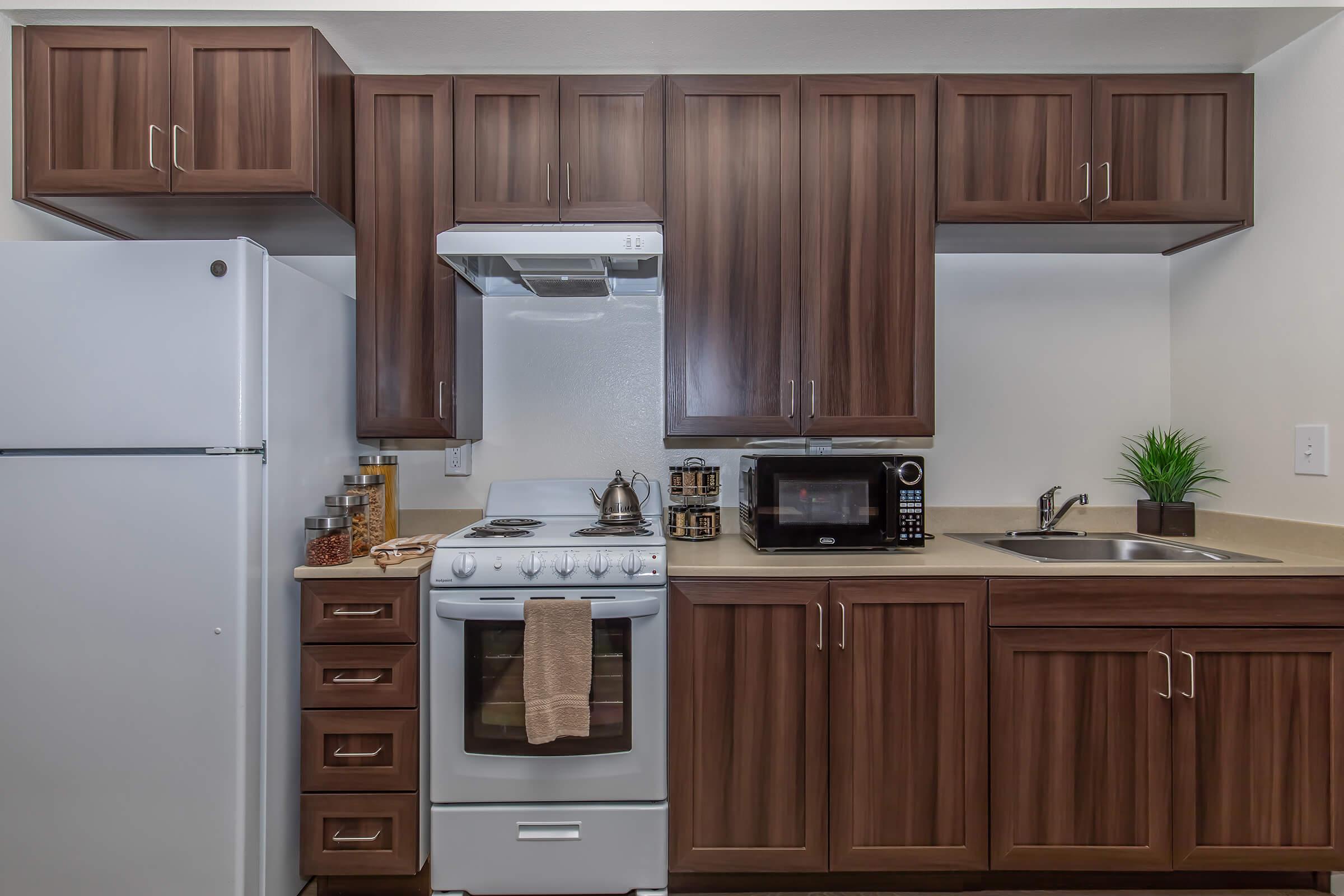 a kitchen with stainless steel appliances and wooden cabinets