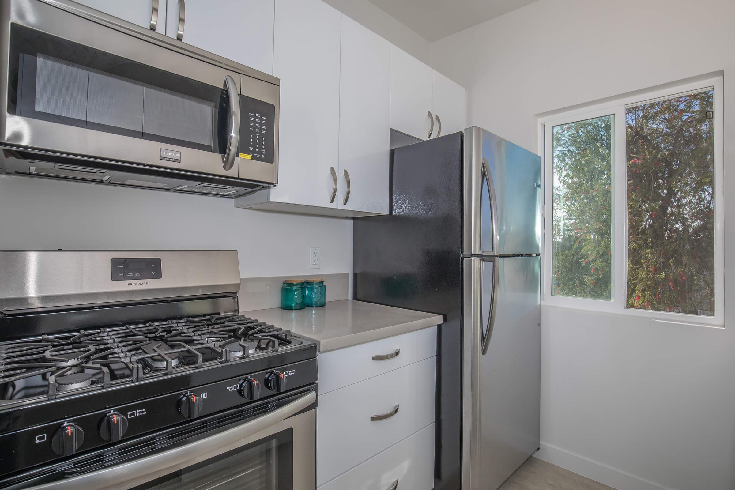 a stove top oven sitting inside of a kitchen