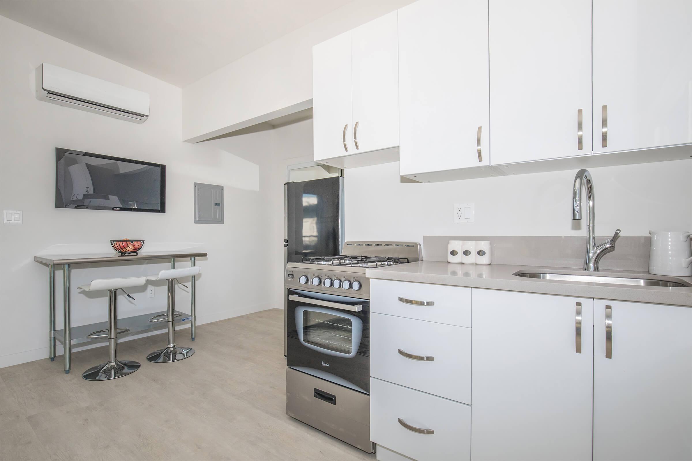 a kitchen with a stove top oven sitting inside of a room