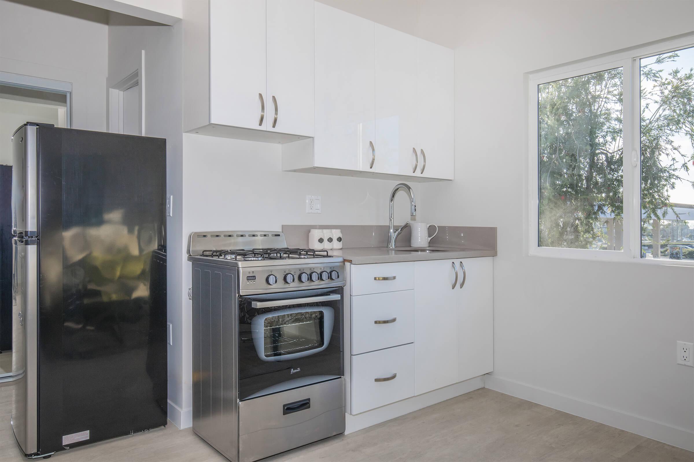 a kitchen with a stove top oven sitting inside of a refrigerator