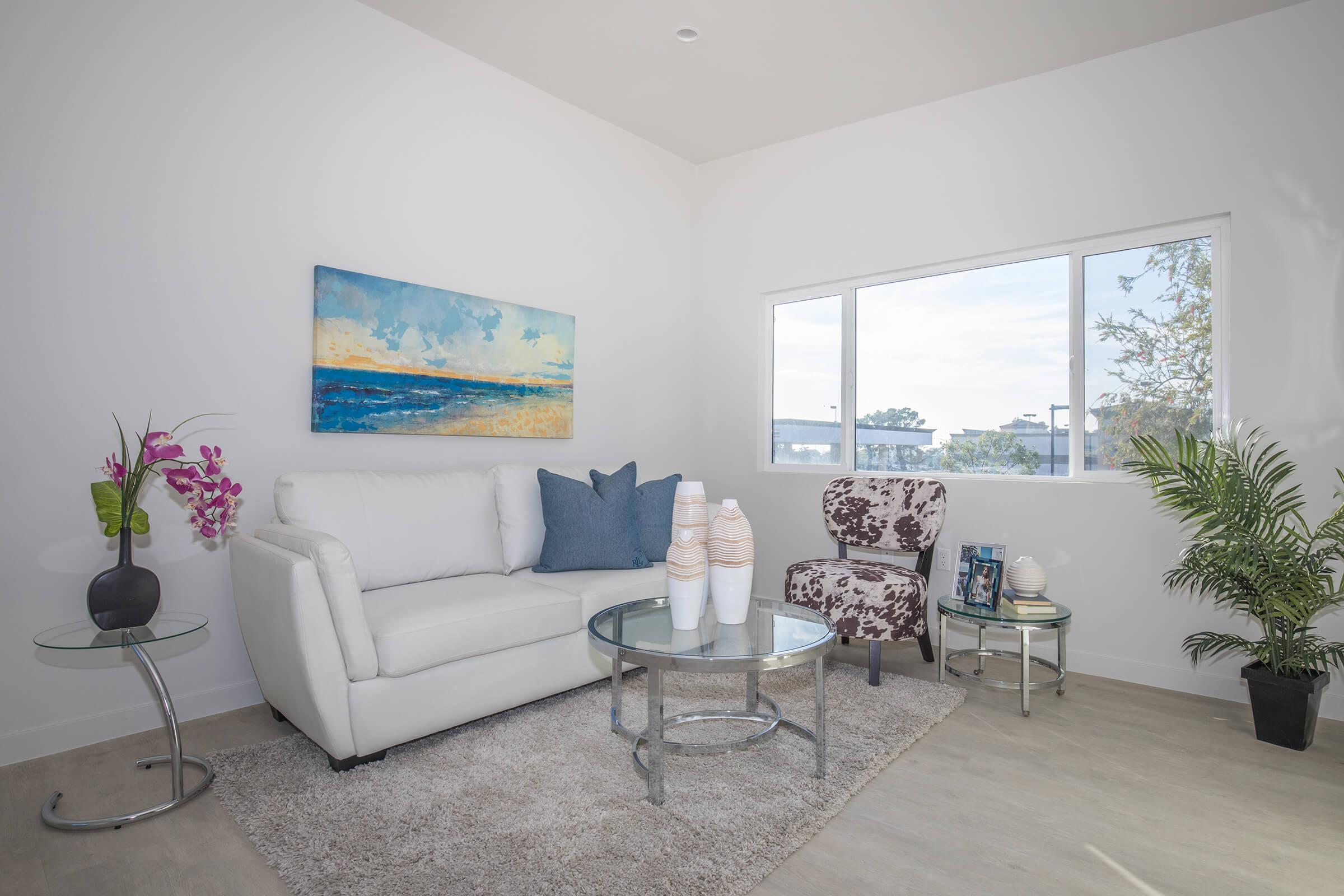 a living room filled with furniture and a large window