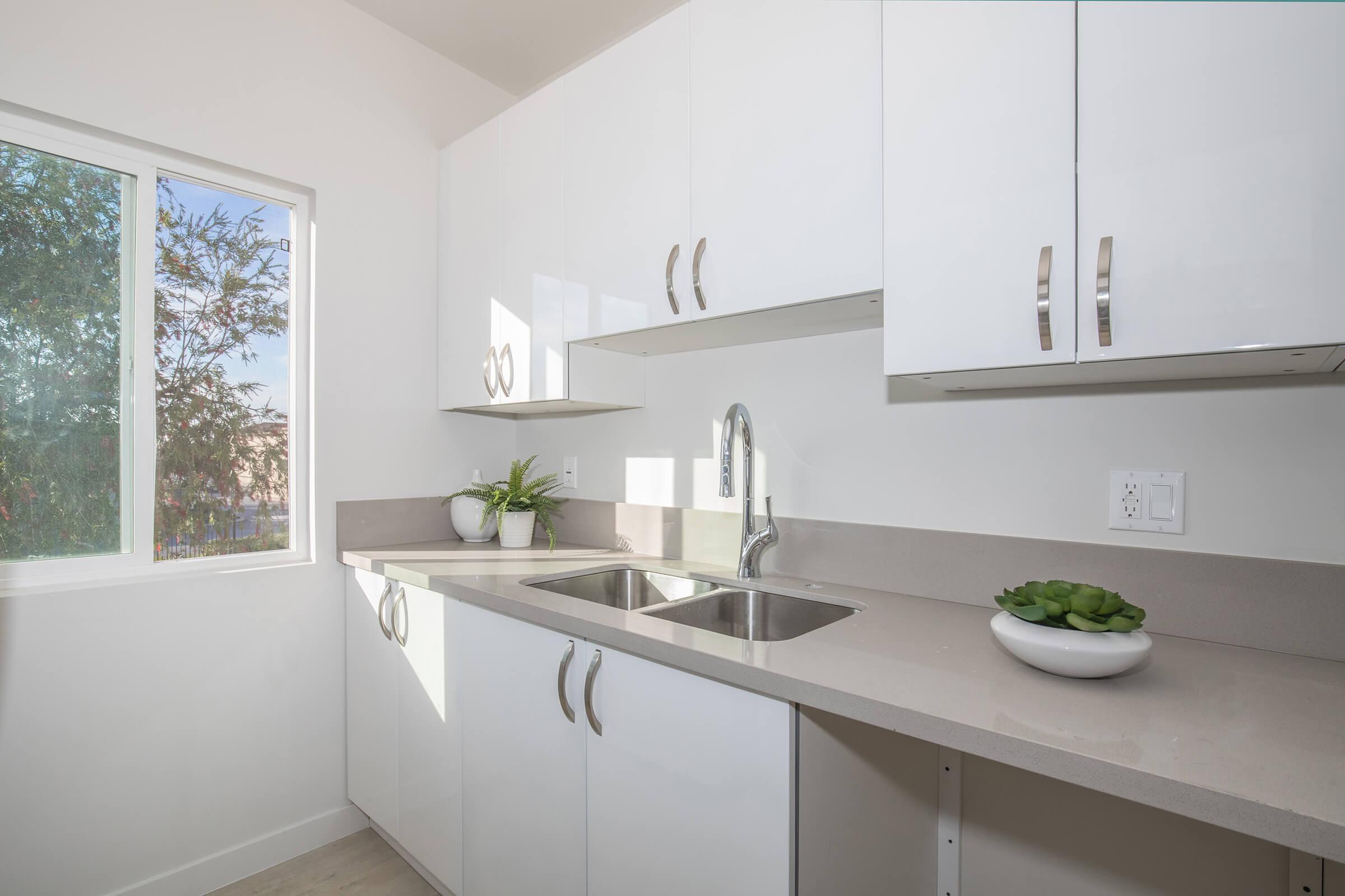 a kitchen with a sink a mirror and a window