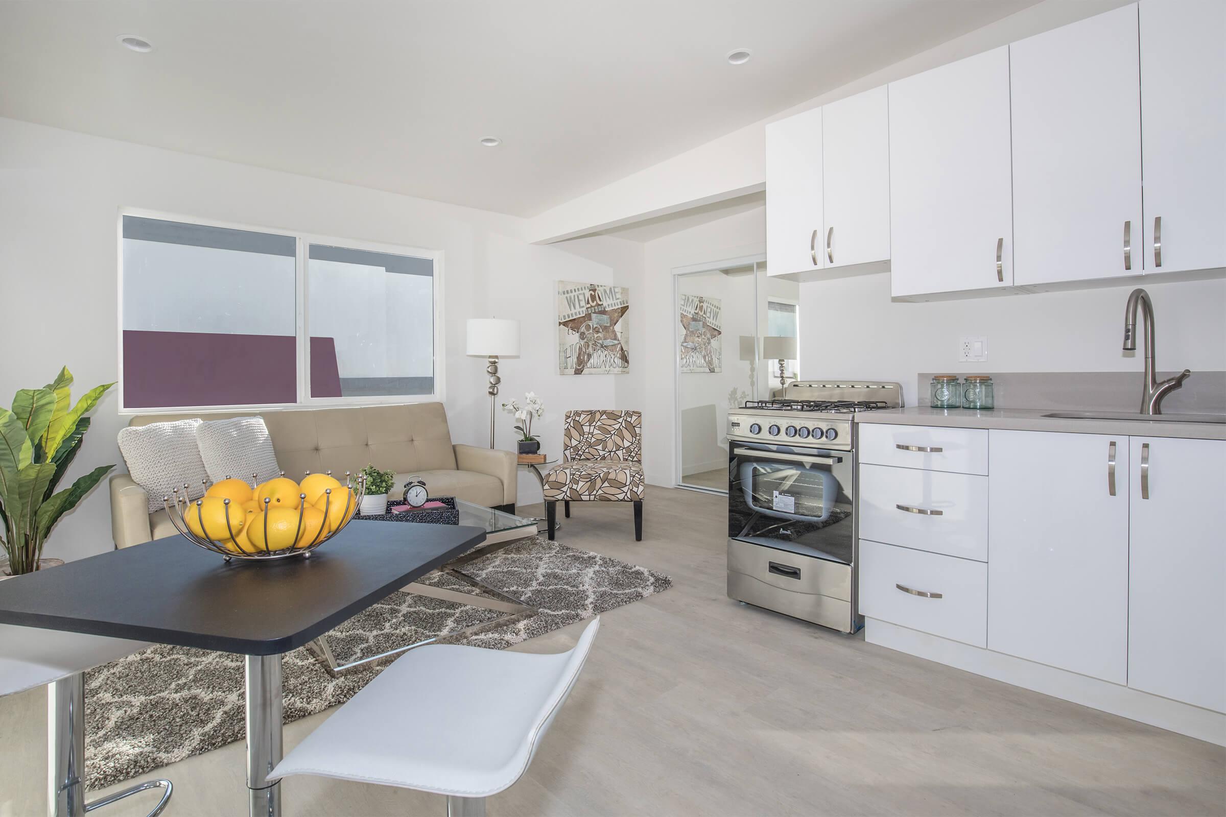 a kitchen filled with lots of furniture