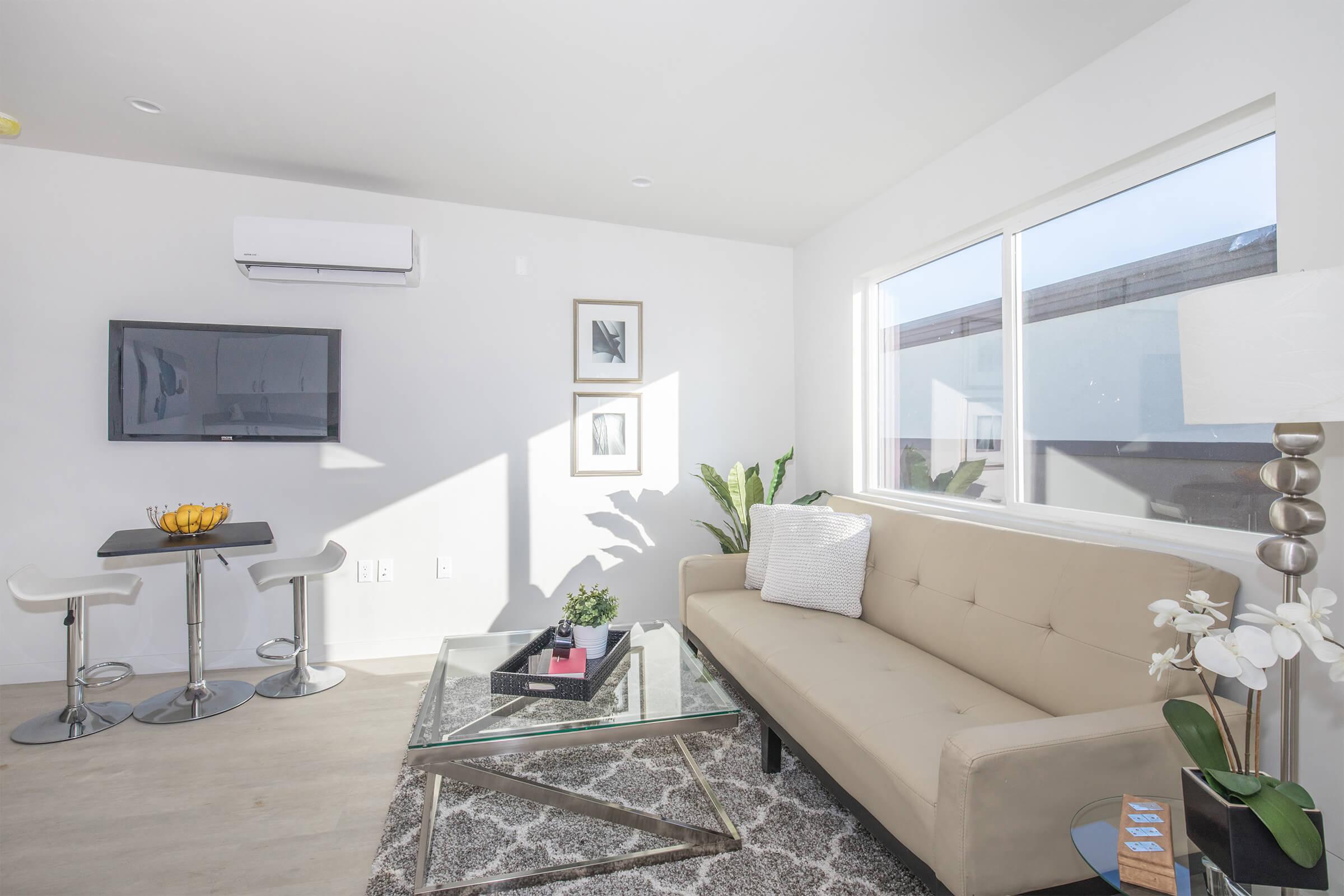 a living room filled with furniture and a flat screen tv