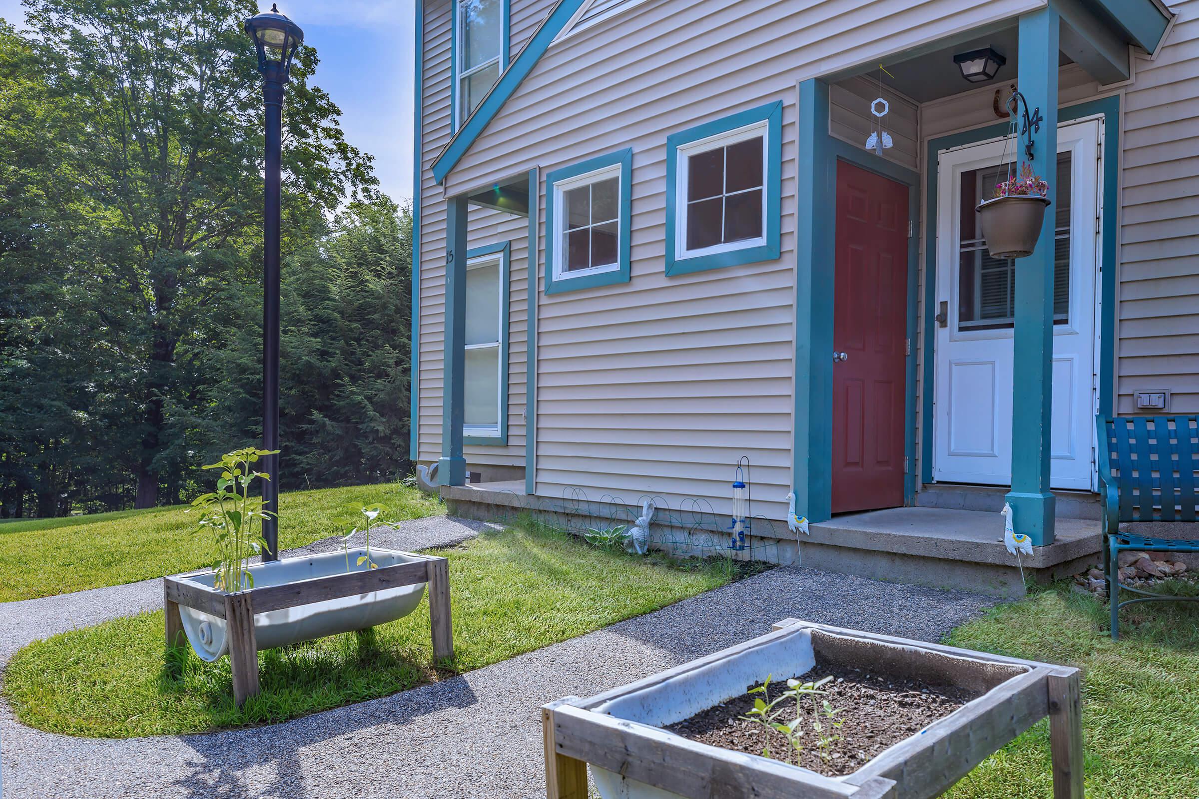 a blue bench in front of a house