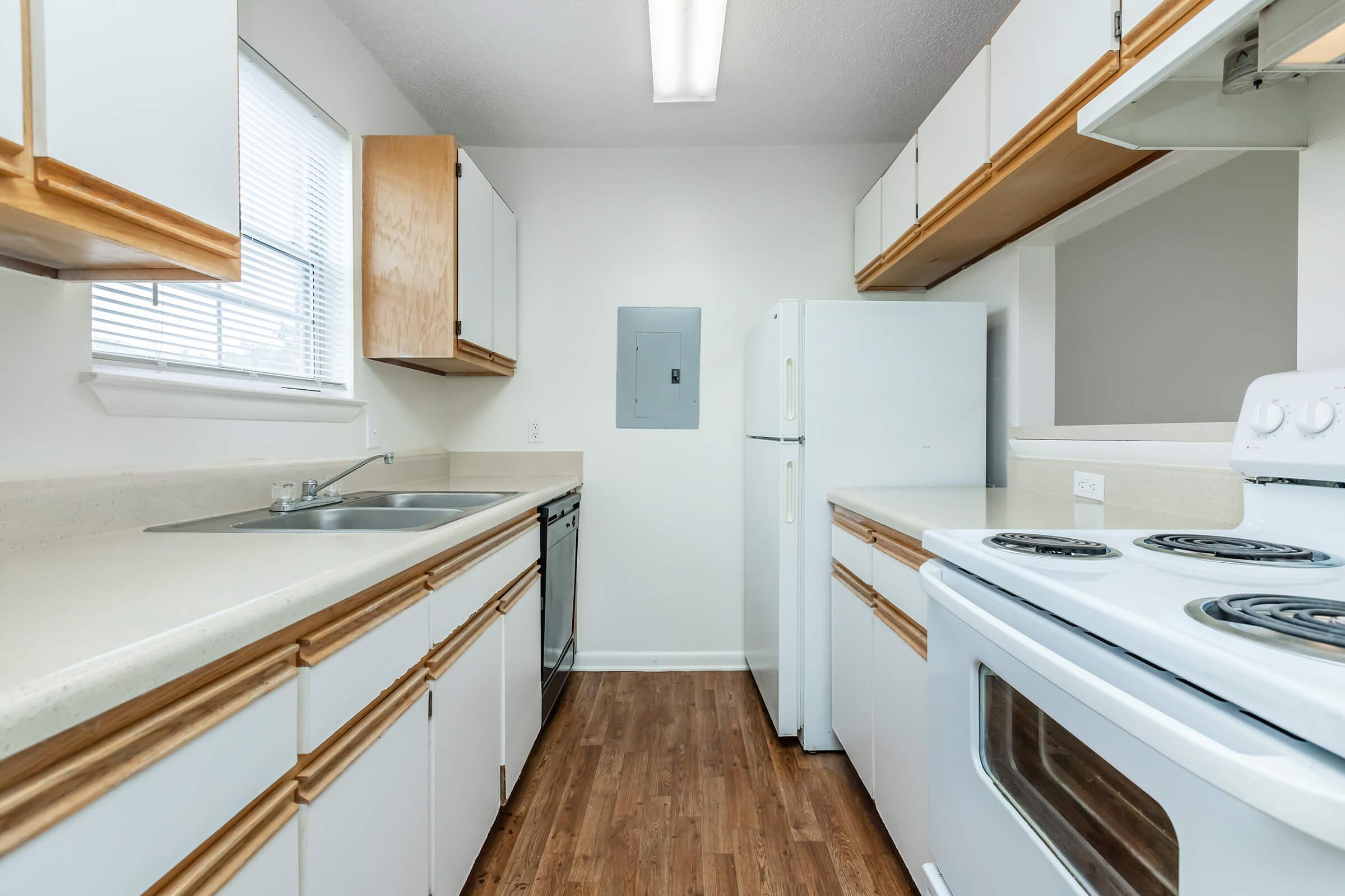 a kitchen with a stove sink and refrigerator