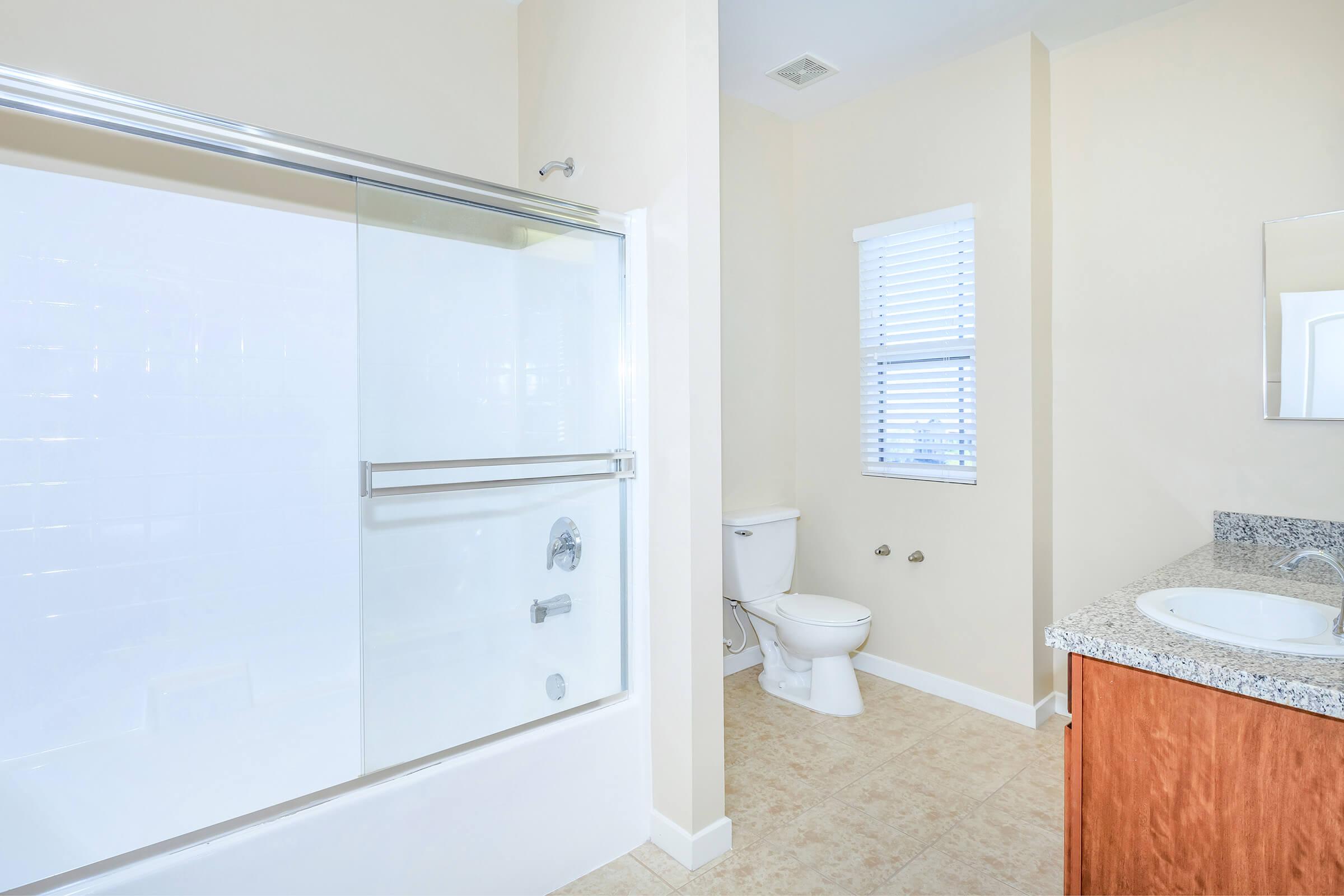 Unfurnished bathroom with wooden cabinets