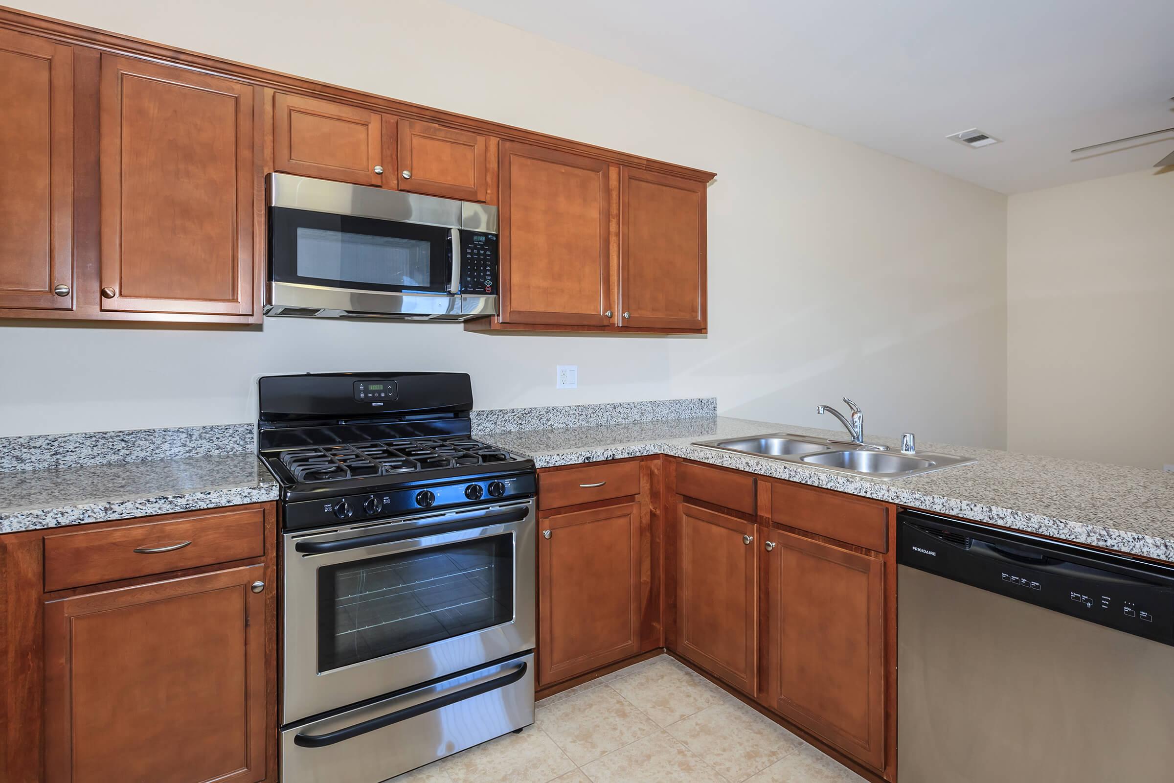 a kitchen with stainless steel appliances and wooden cabinets