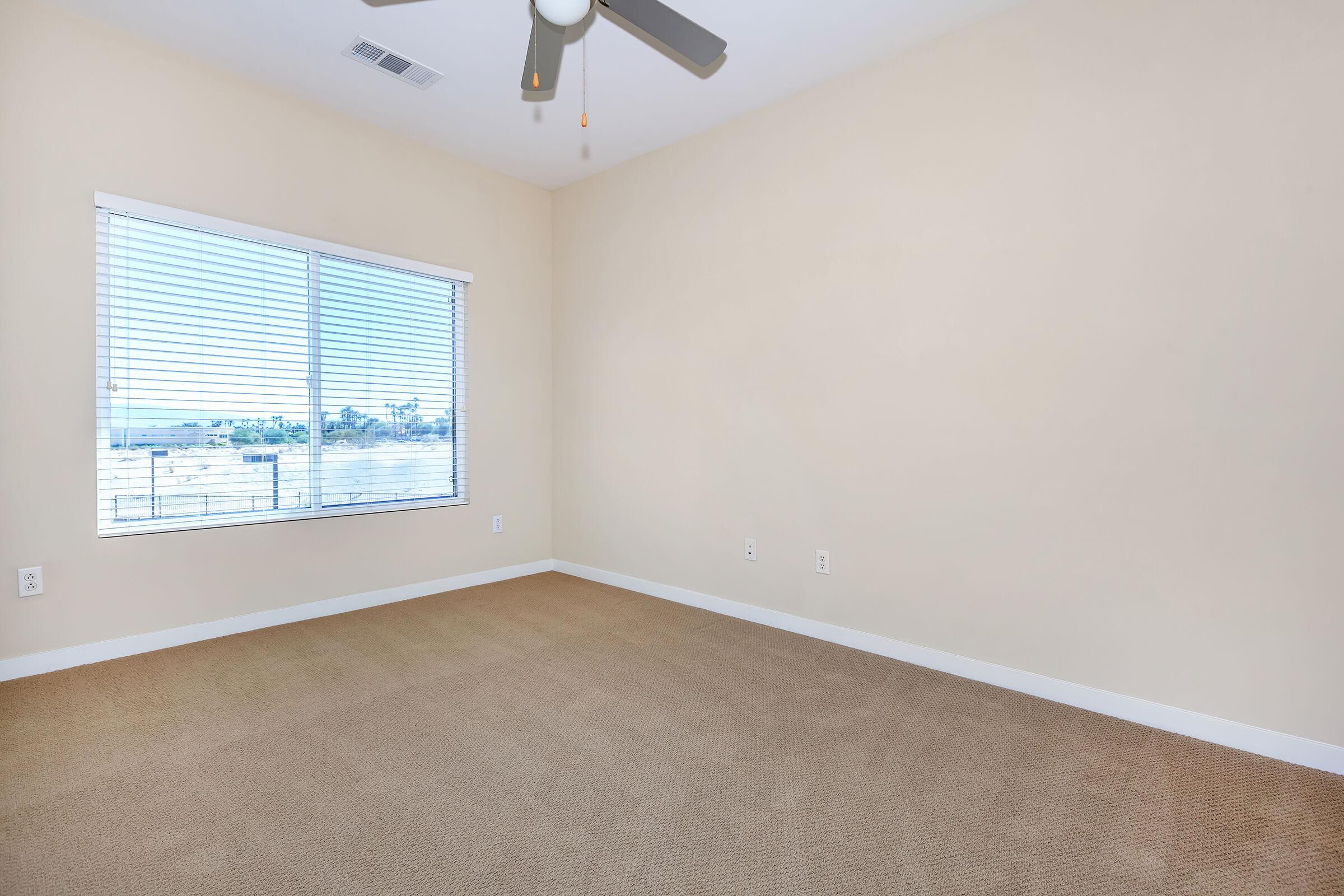 a bedroom with a large window