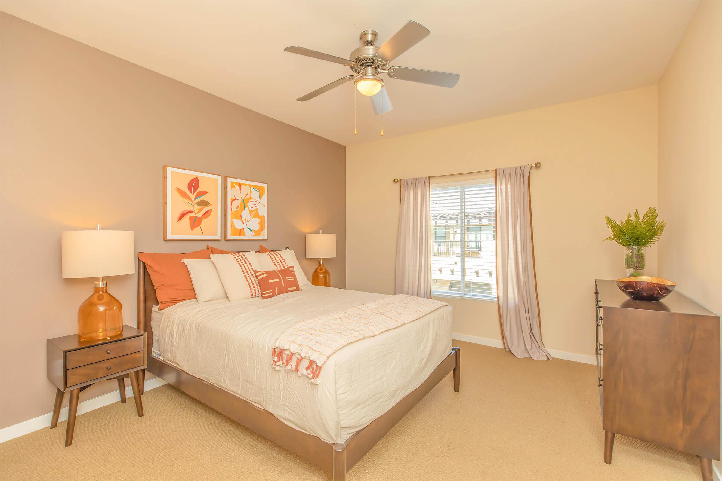 Bedroom with orange accent pillows