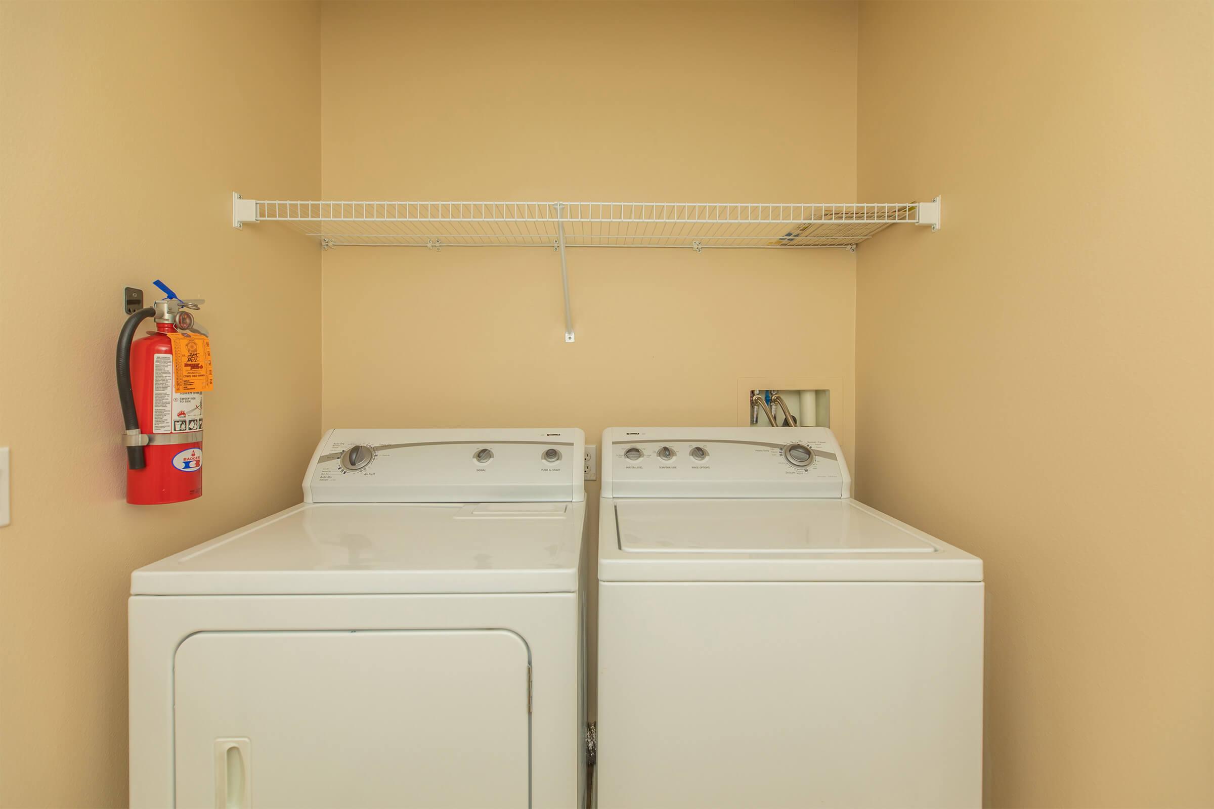 a washer and dryer with a fire extinguisher 