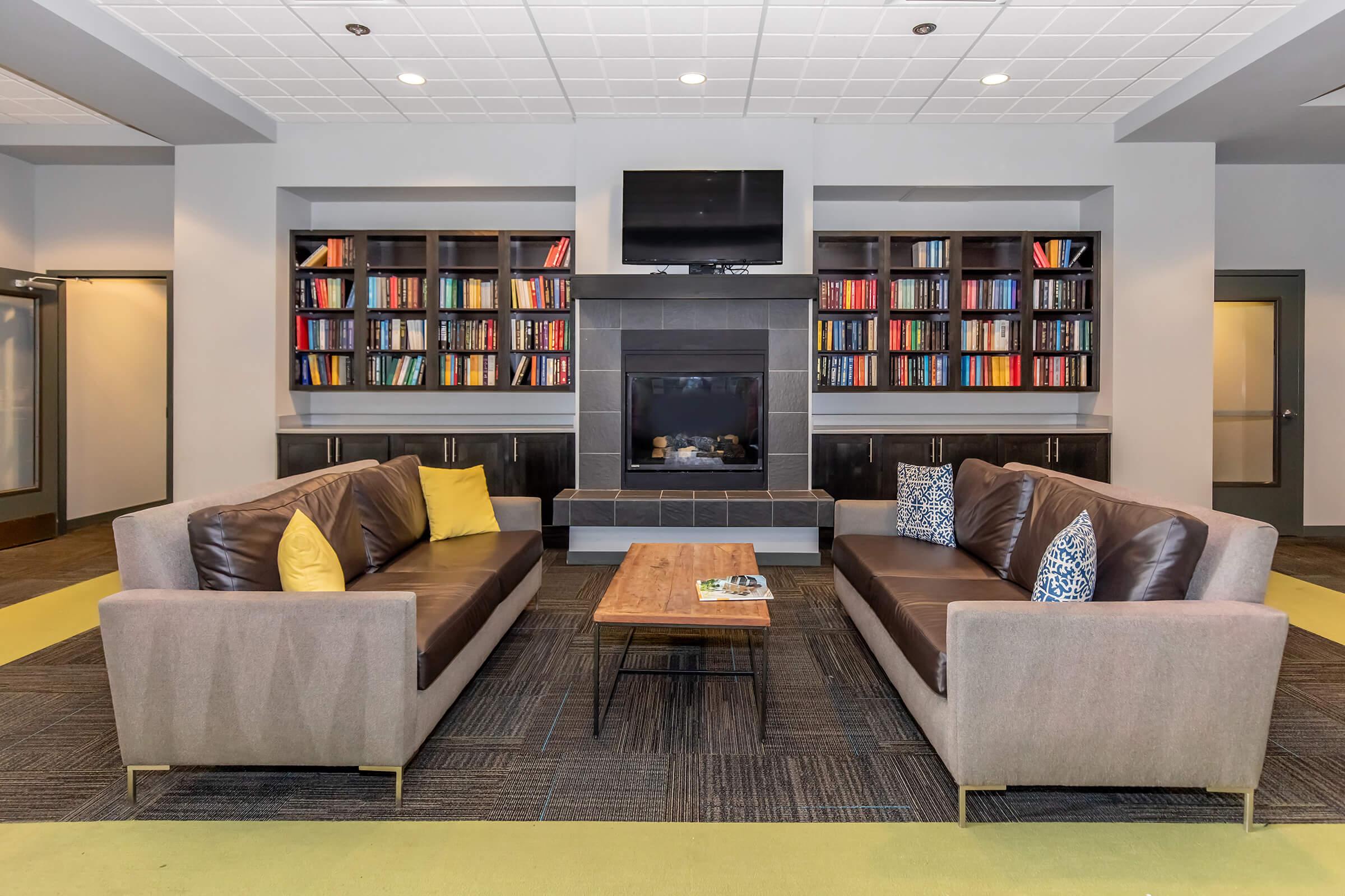 a living room filled with furniture and a flat screen tv