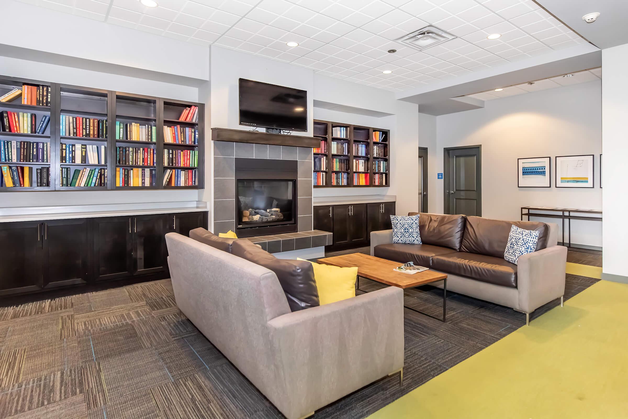 a living room filled with furniture and a flat screen tv