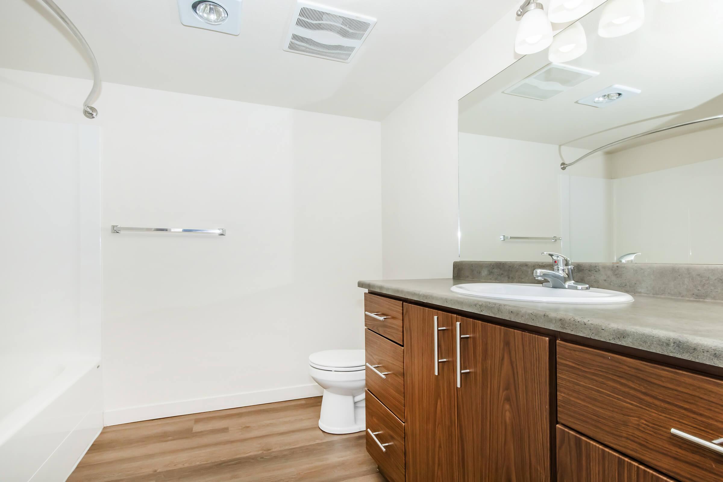 a kitchen with a sink and a mirror