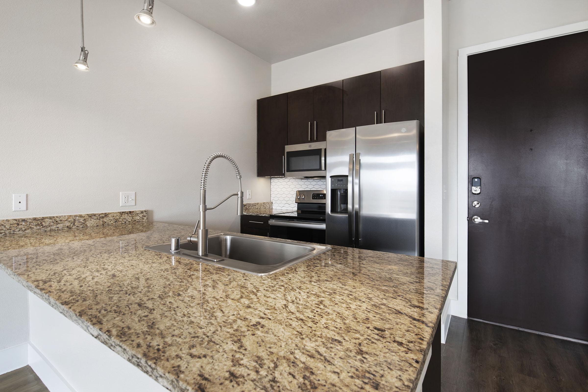 a kitchen with a sink and a mirror